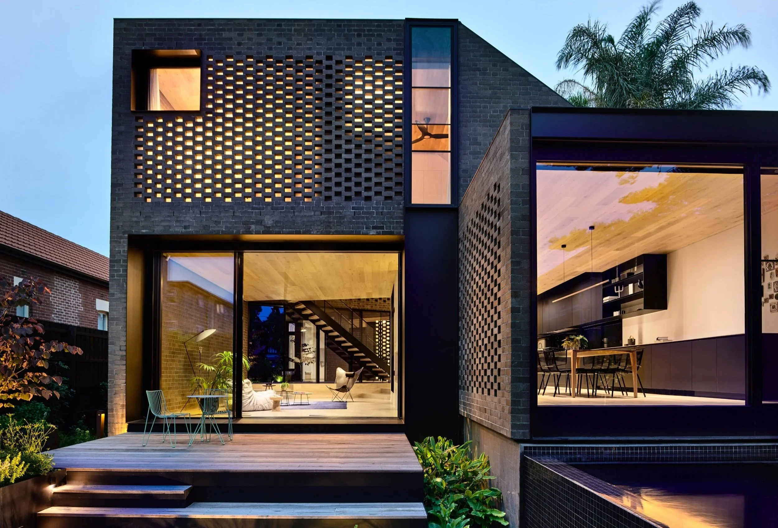 Contemporary brick residence with large glazing, screened masonry facade and complex building envelope detailing