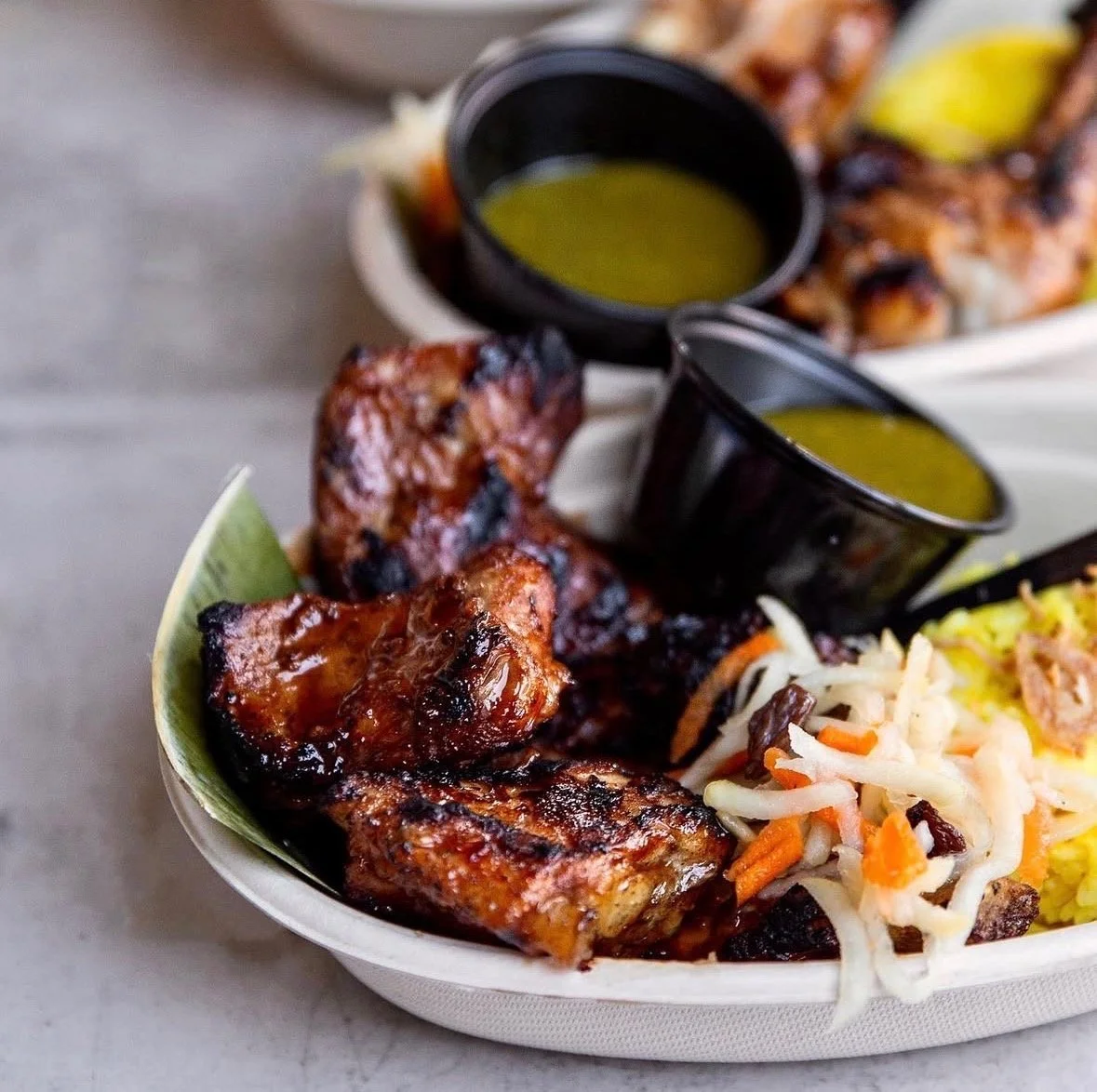 pork bbq on s skewer, green sauce, coconut rice and some vegetables