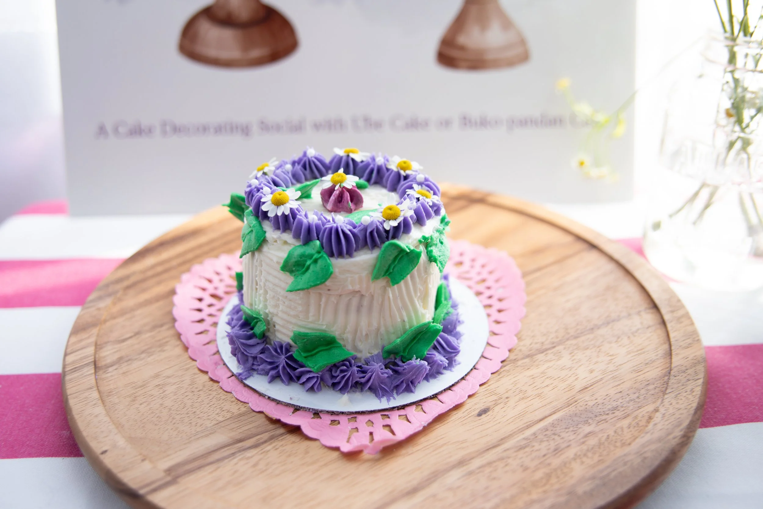 mini cake decorated with green and purple buttercream