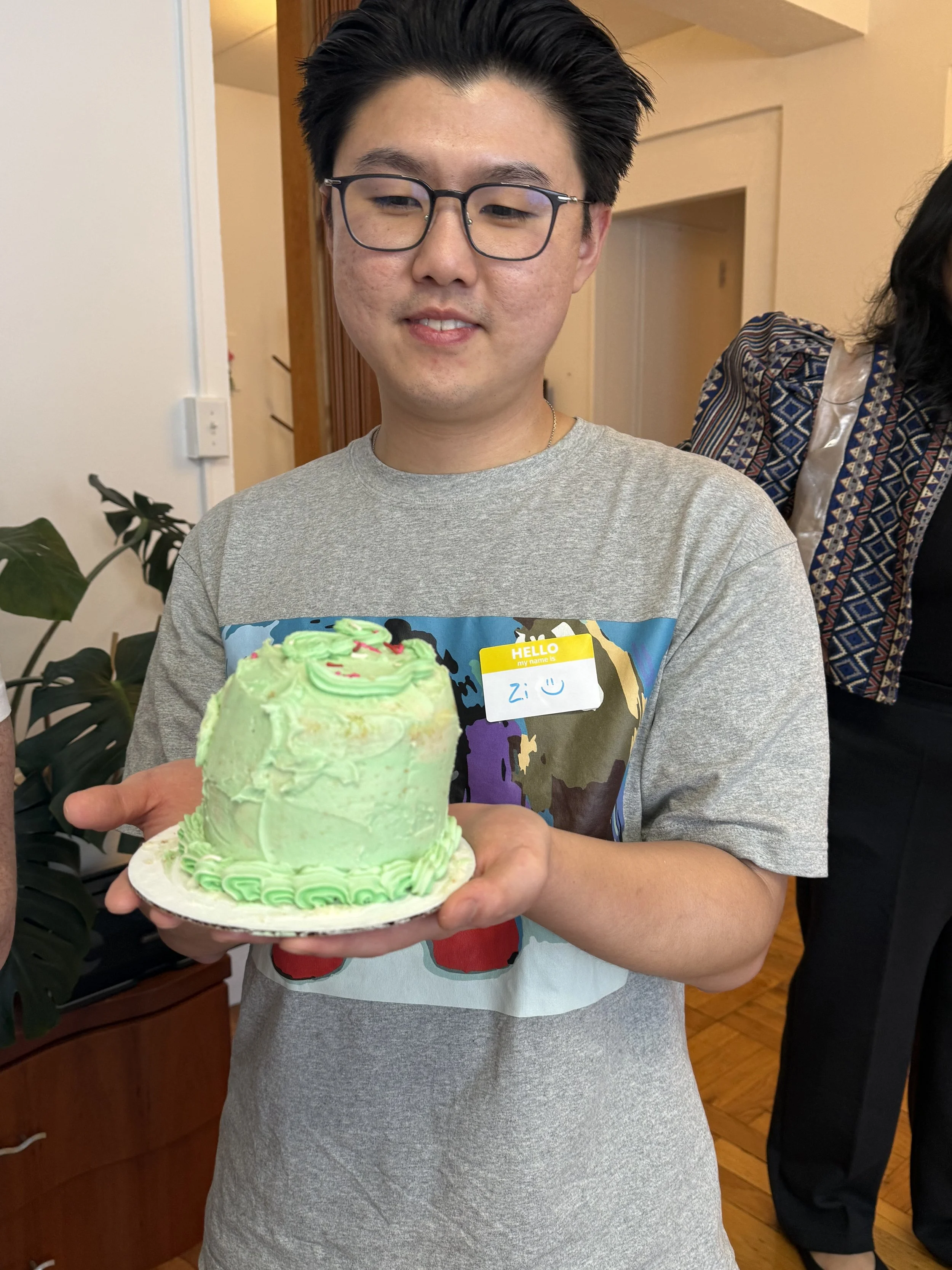 Happy guy holding his decorated cake