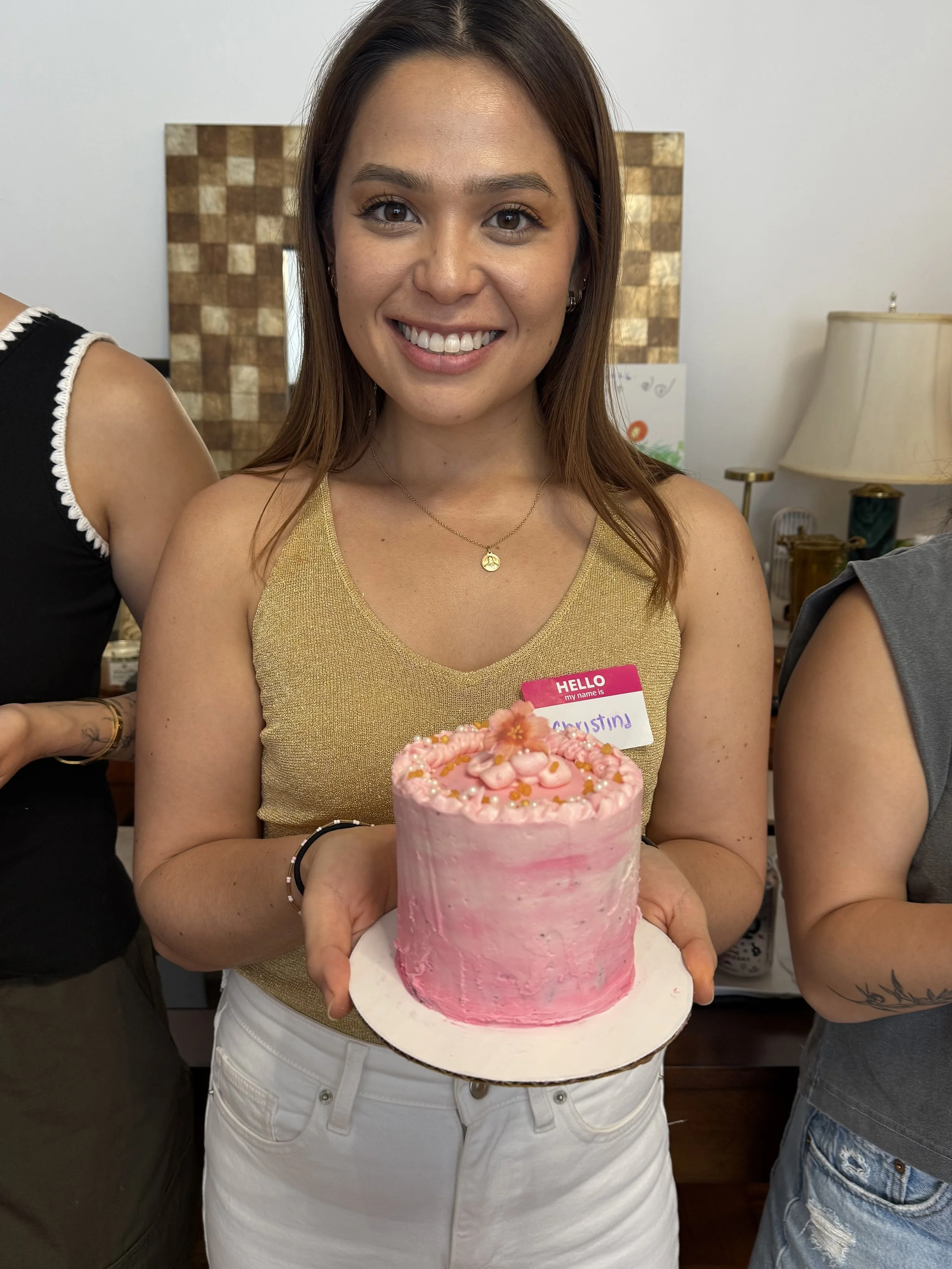 Beautiful girl holding her decorated cake