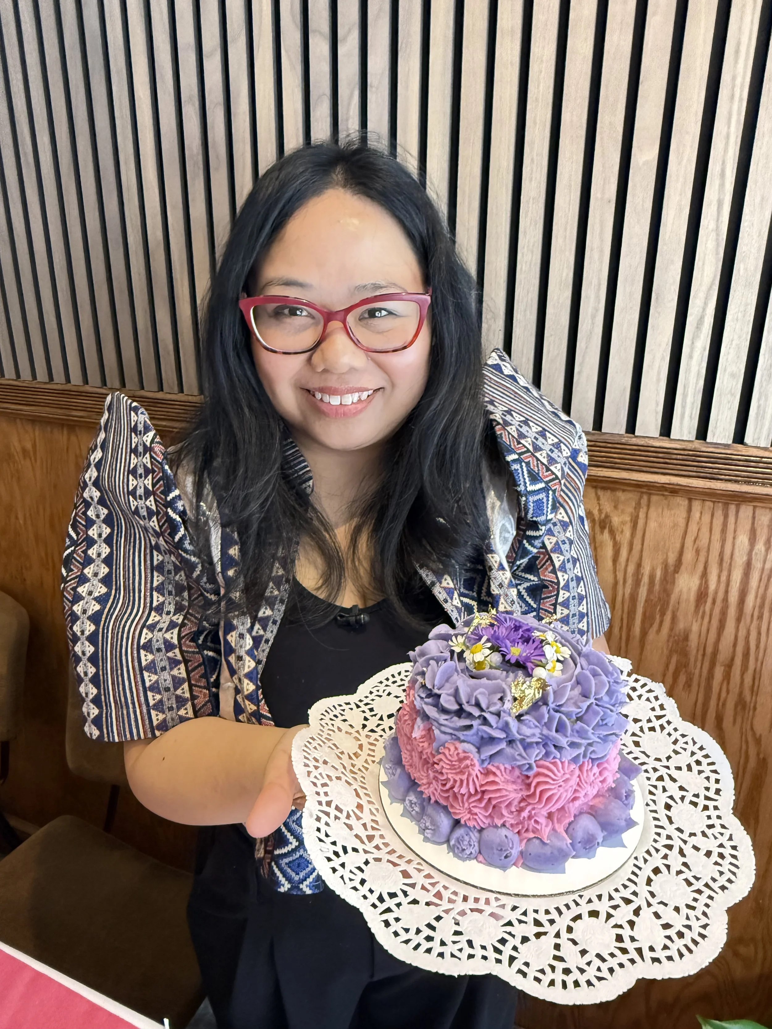Woman holding a colorful cake