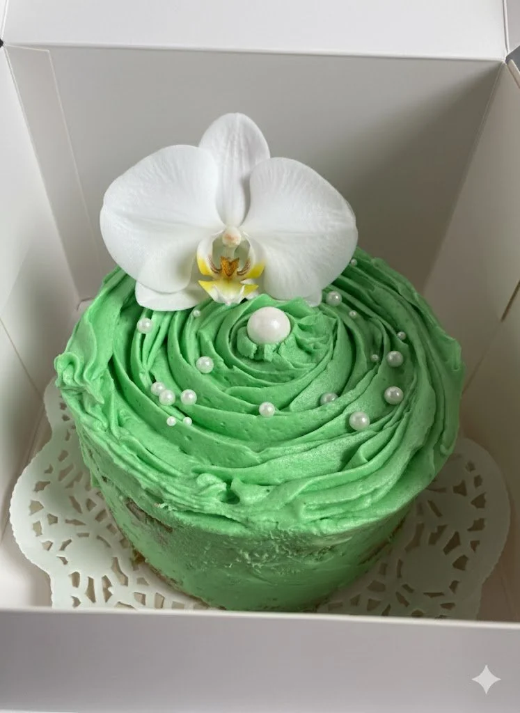 pandan cake with pearls and white orchid