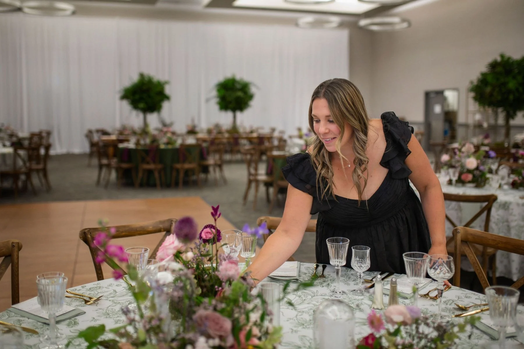 A photo of Brandy Maddison adding florals to a table setting