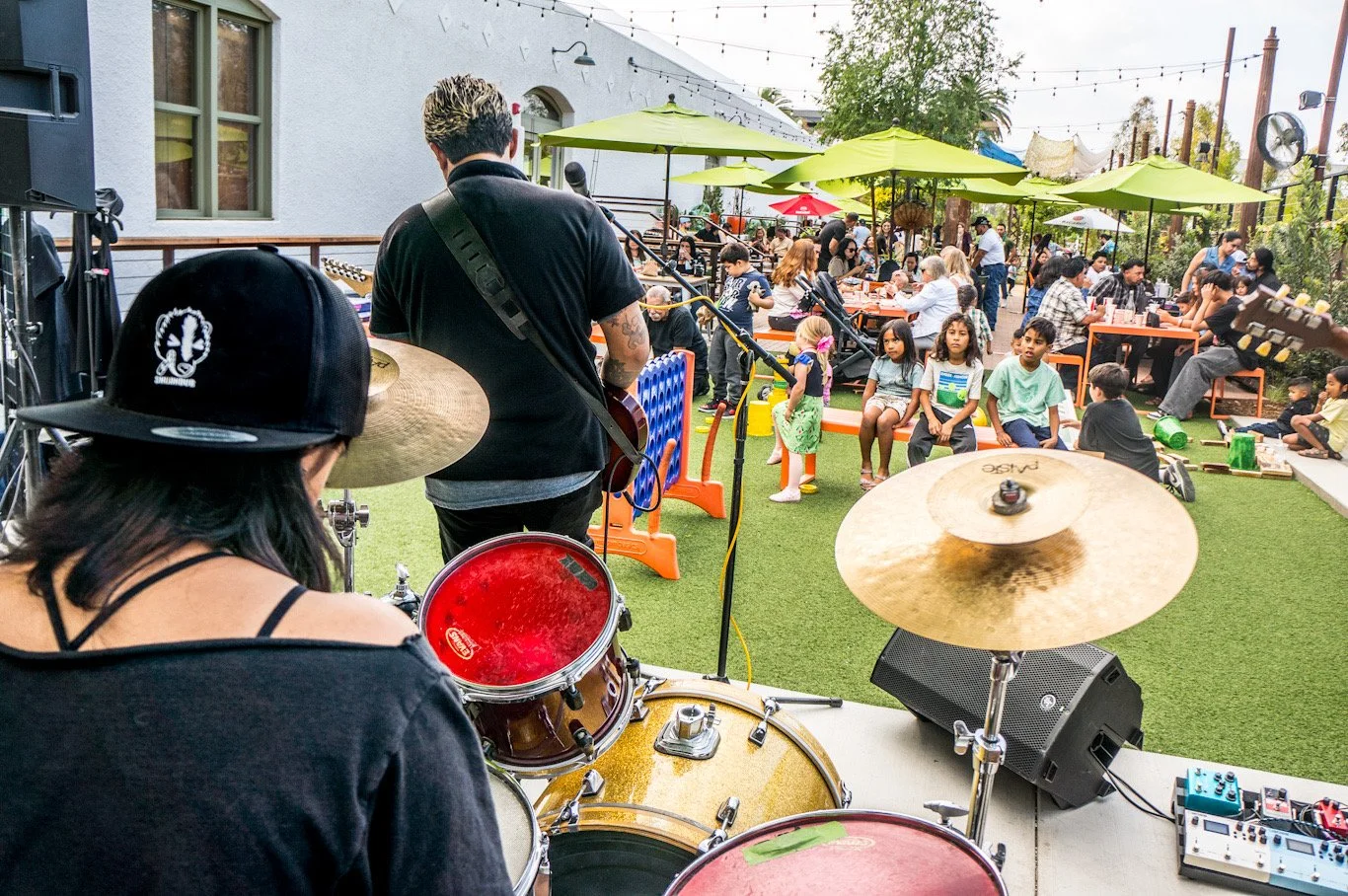 Picture shot behind drummer, of SKUNKDUB and the audience