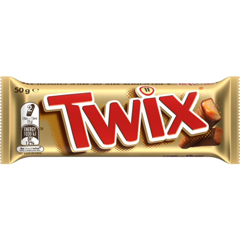 Golden wrapper of Twix chocolate bar with visible caramel and biscuit pieces.