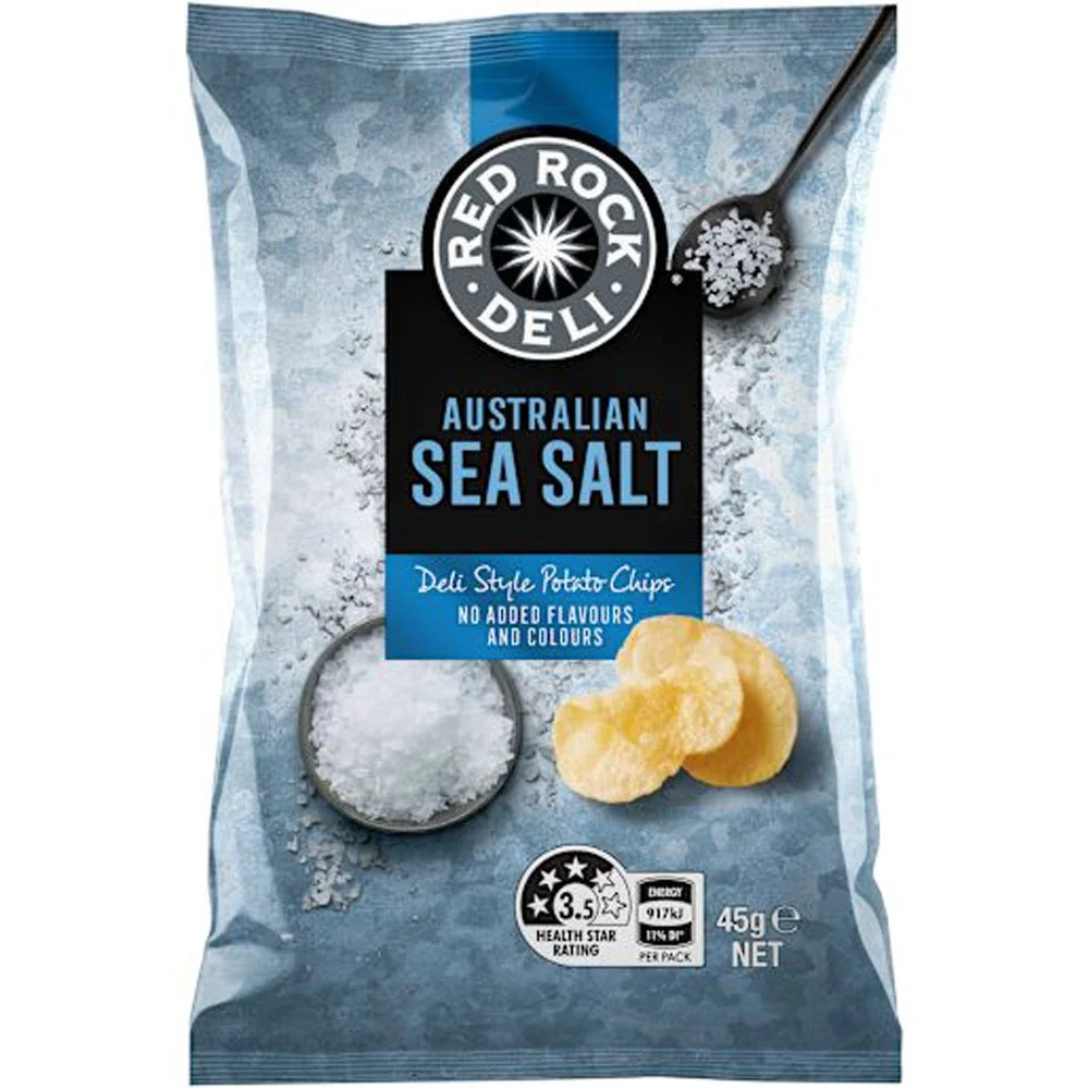 A bag of Red Rock Deli Australian sea salt potato chips, featuring an image of salt crystals on a spoon and a couple of potato chips, with nutritional information and a health star rating.
