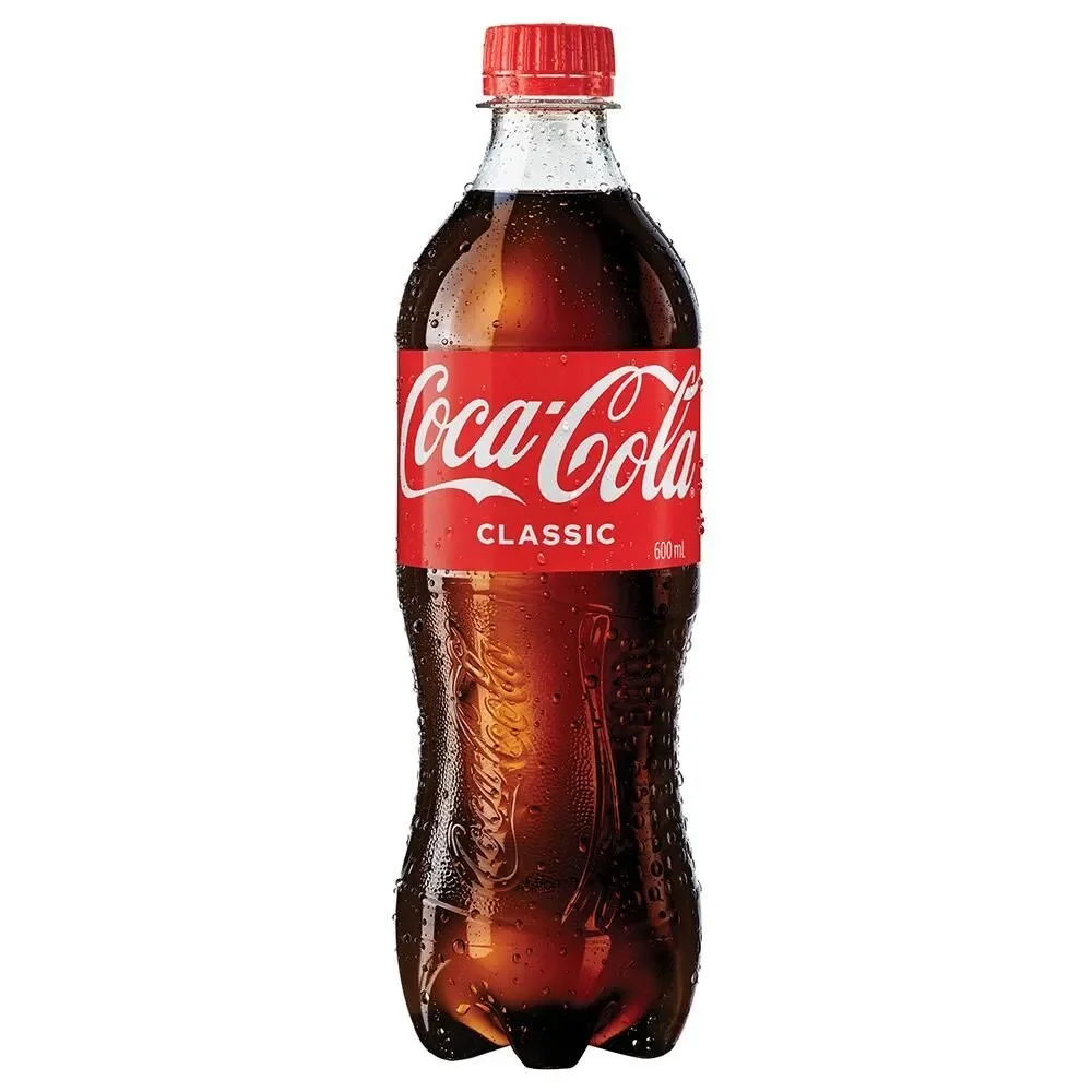 A 20-ounce Coca-Cola Classic bottle with a red cap, filled with dark soda, with condensation droplets on the surface, set against a white background.