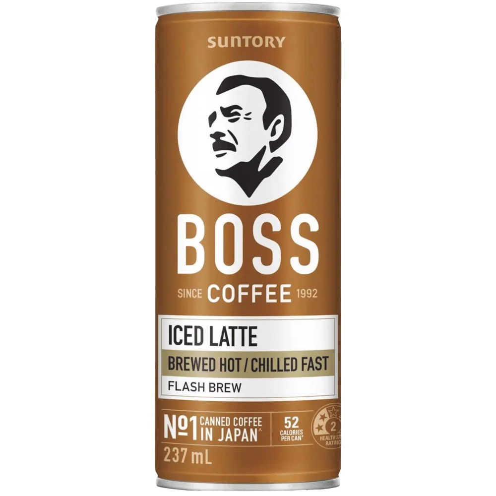 A can of Boss Coffee Iced Latte, brewed hot and served chilled fast. The can is brown with a white logo of a man's face and the text 'Boss Coffee.' It states it is canned coffee in Japan, with 52 calories per can and a 2-star health rating.