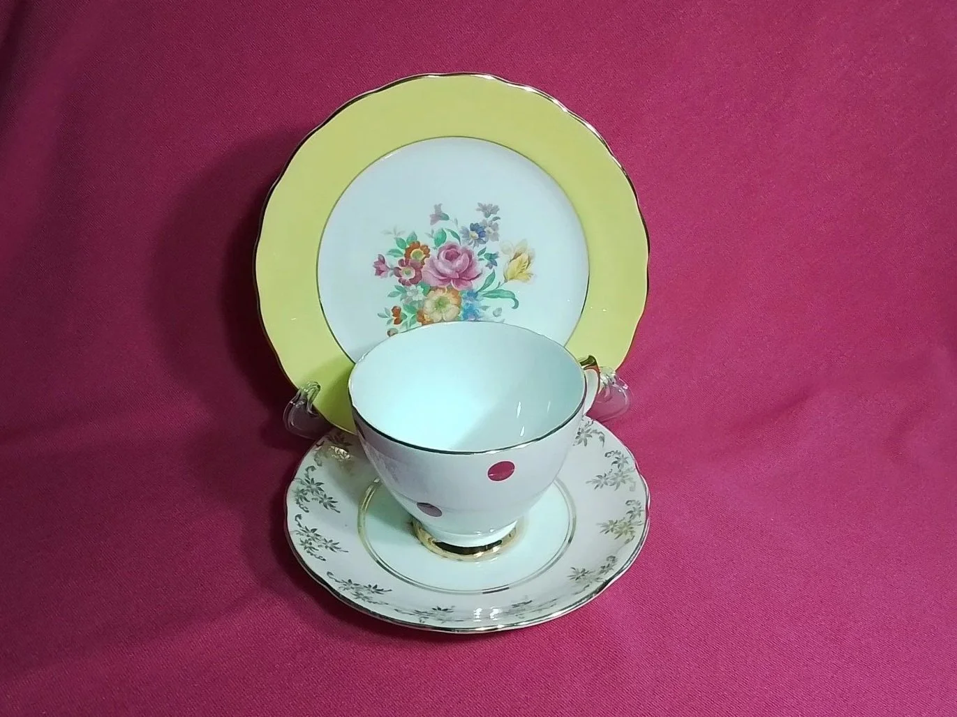 Collection of vintage porcelain teacups and saucers with floral and decorative patterns, stacked and arranged on a surface.
