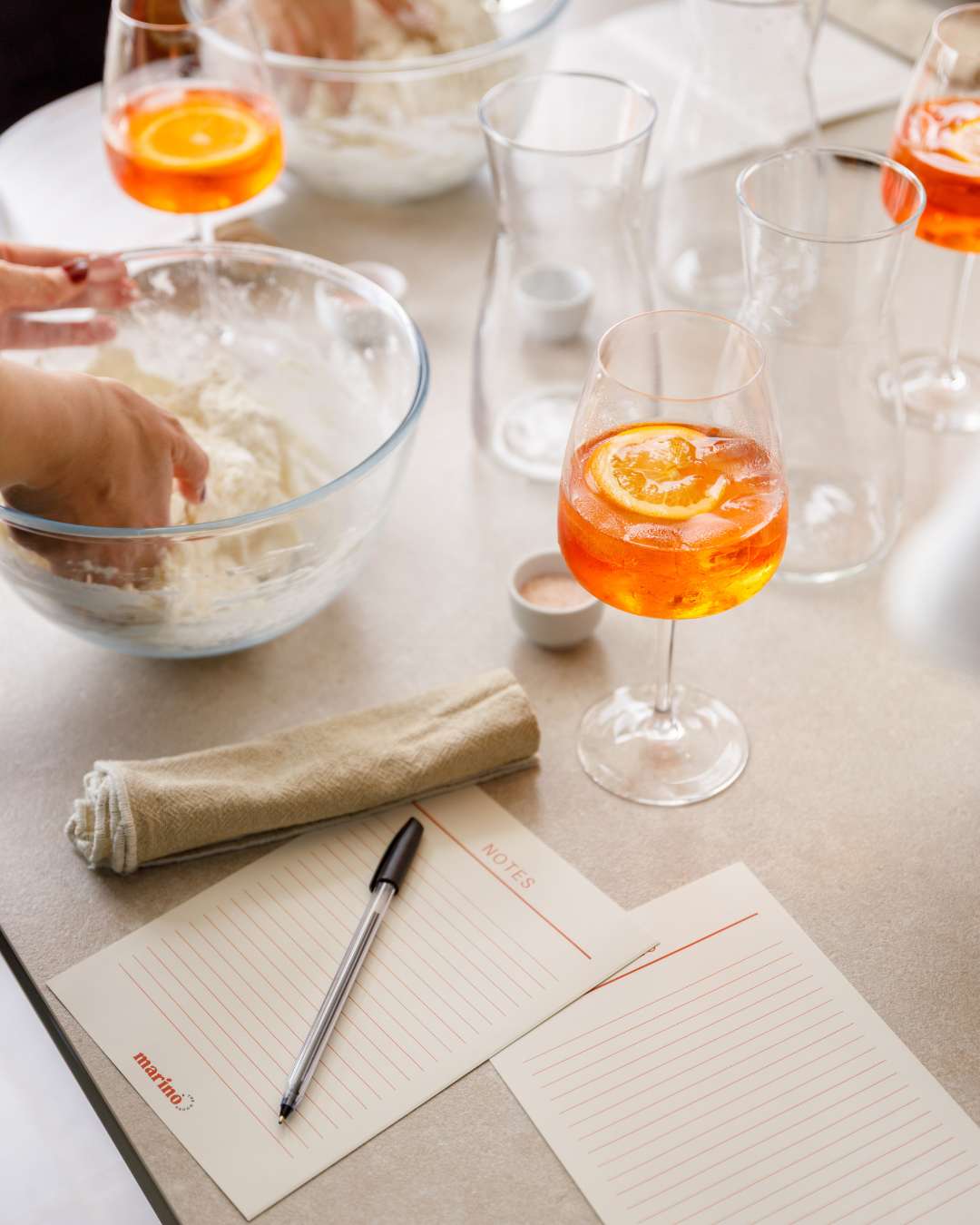 Guests mixing pizza dough together while enjoying drinks during a hands on Marino & The Dough masterclass.