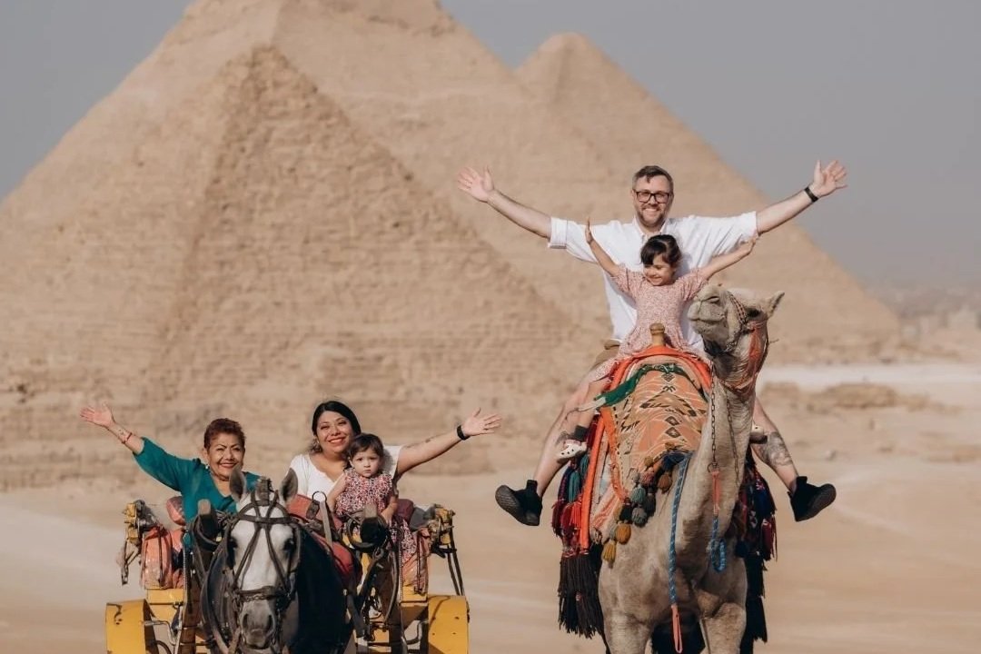 family on camels in giza egypt