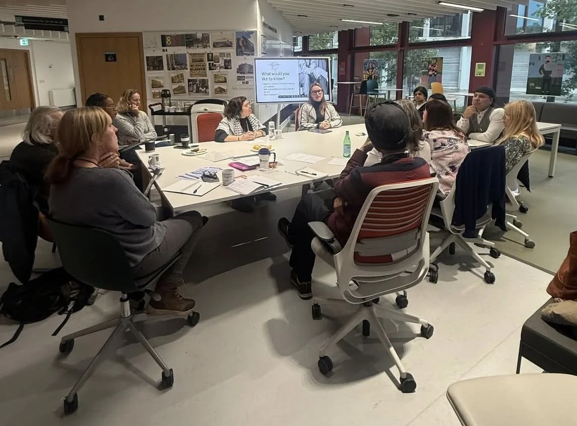 I hosted a Byres Hub Monday event where people who were interested in my research came to hear a brief talk and we discussed my research together. Pictured is several people sitting at a round table.