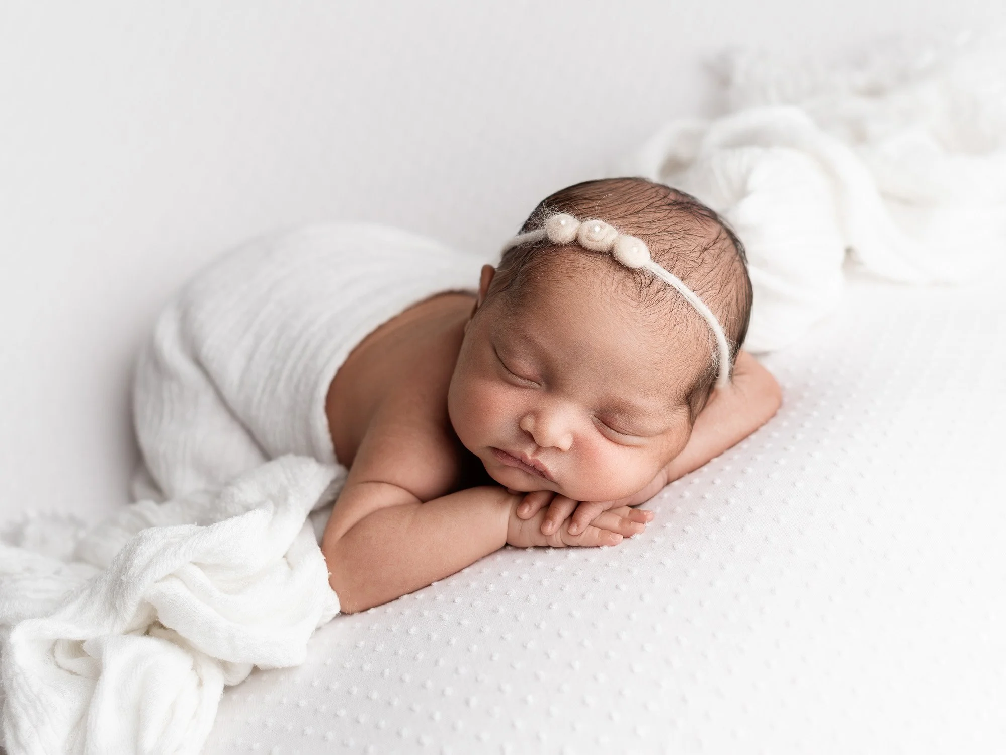 A sleeping newborn baby in a newborn session in High Barnet