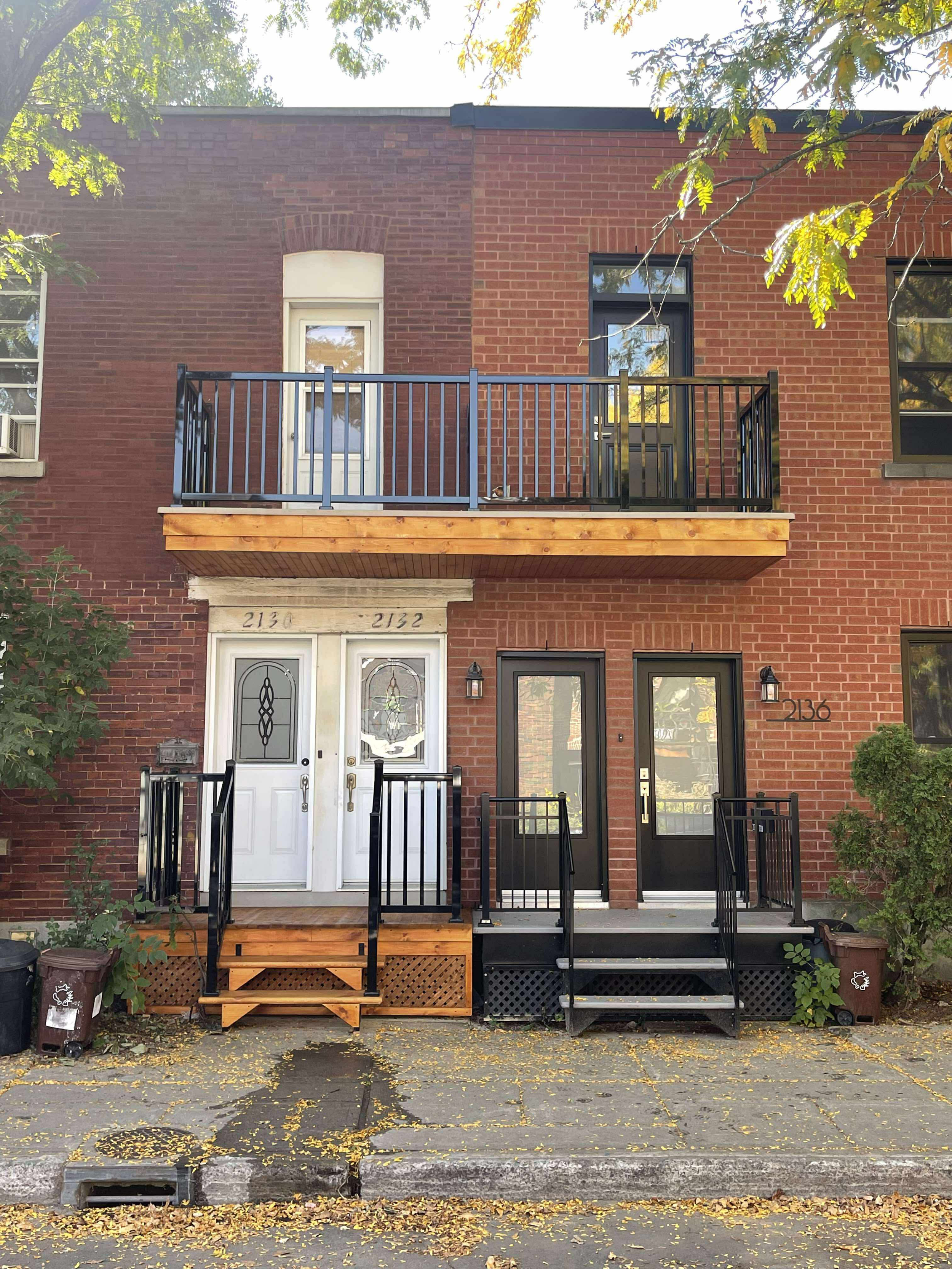 Balcons avant en bois et en fibre de verre avec rampe en aluminium noir. 