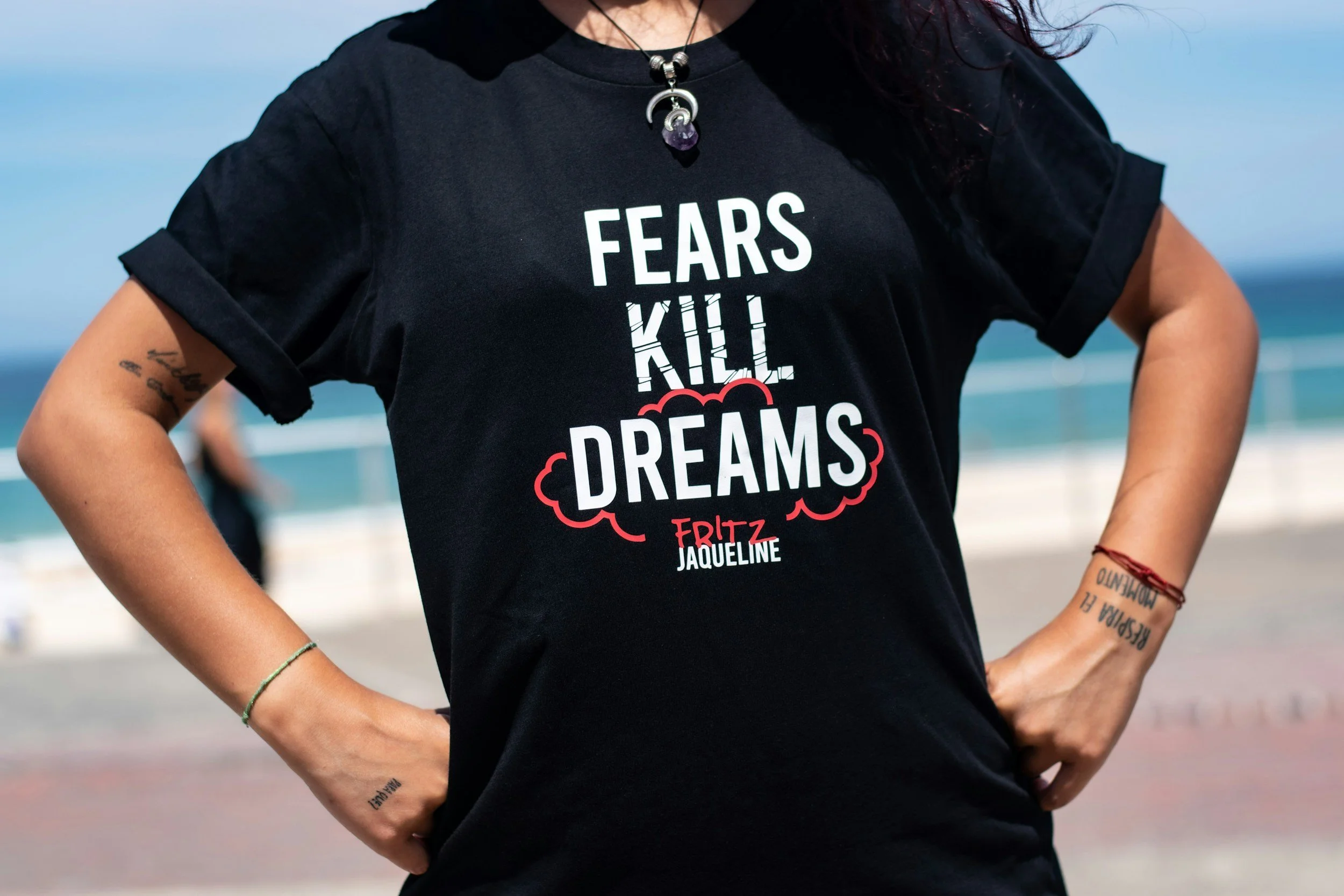 An image of a person wearing a black t-shirt with the words "fears kill dreams" in white capital letters.