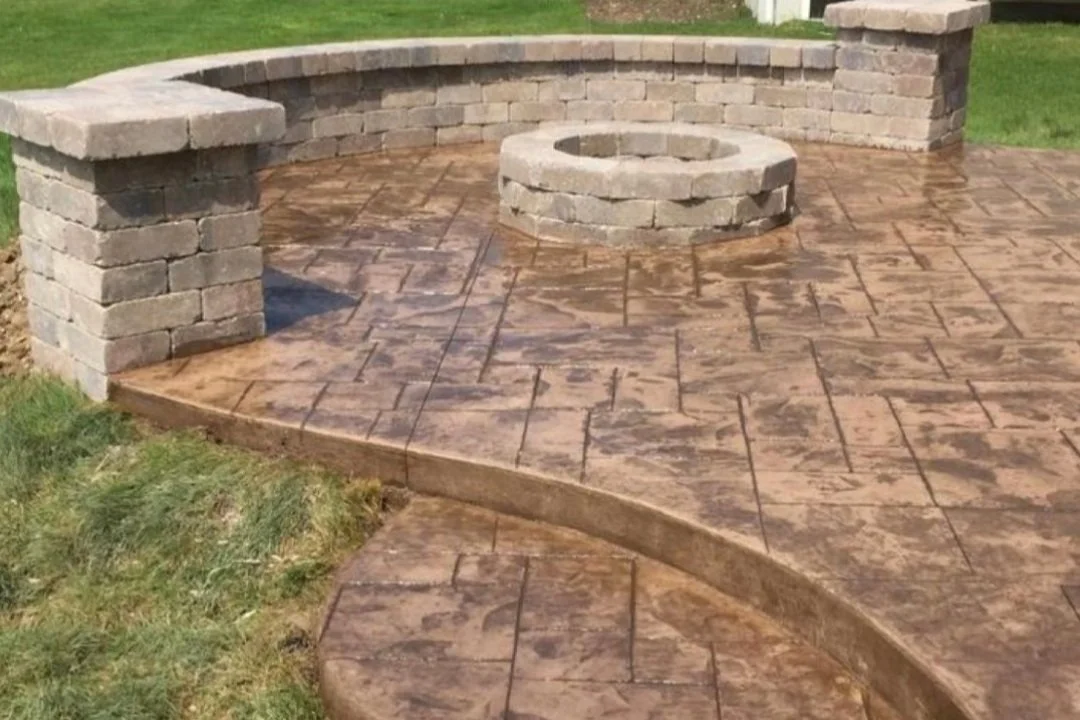 brown patio with seating wall and fire pit.jpg