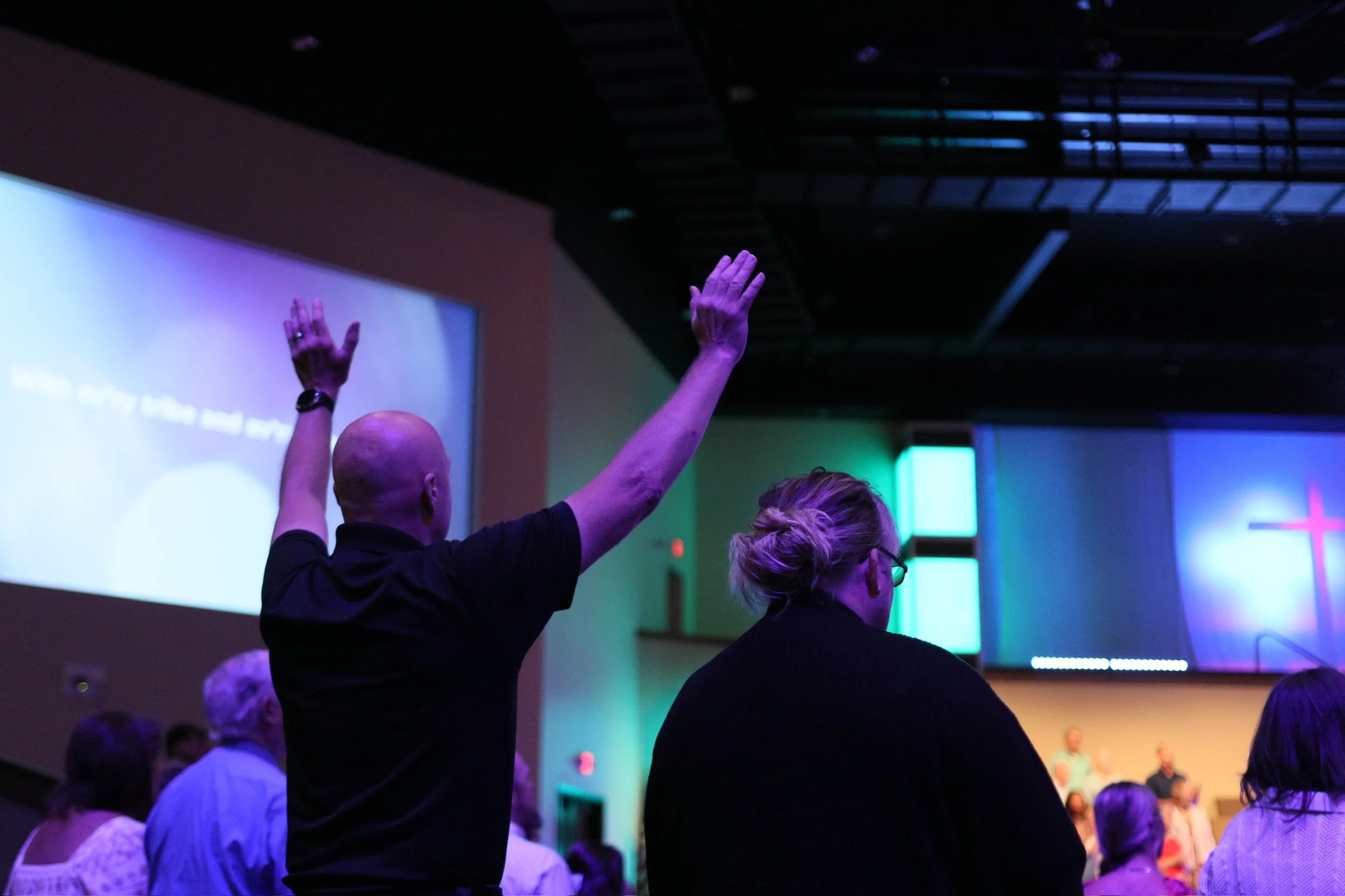 A man raising his hand during service