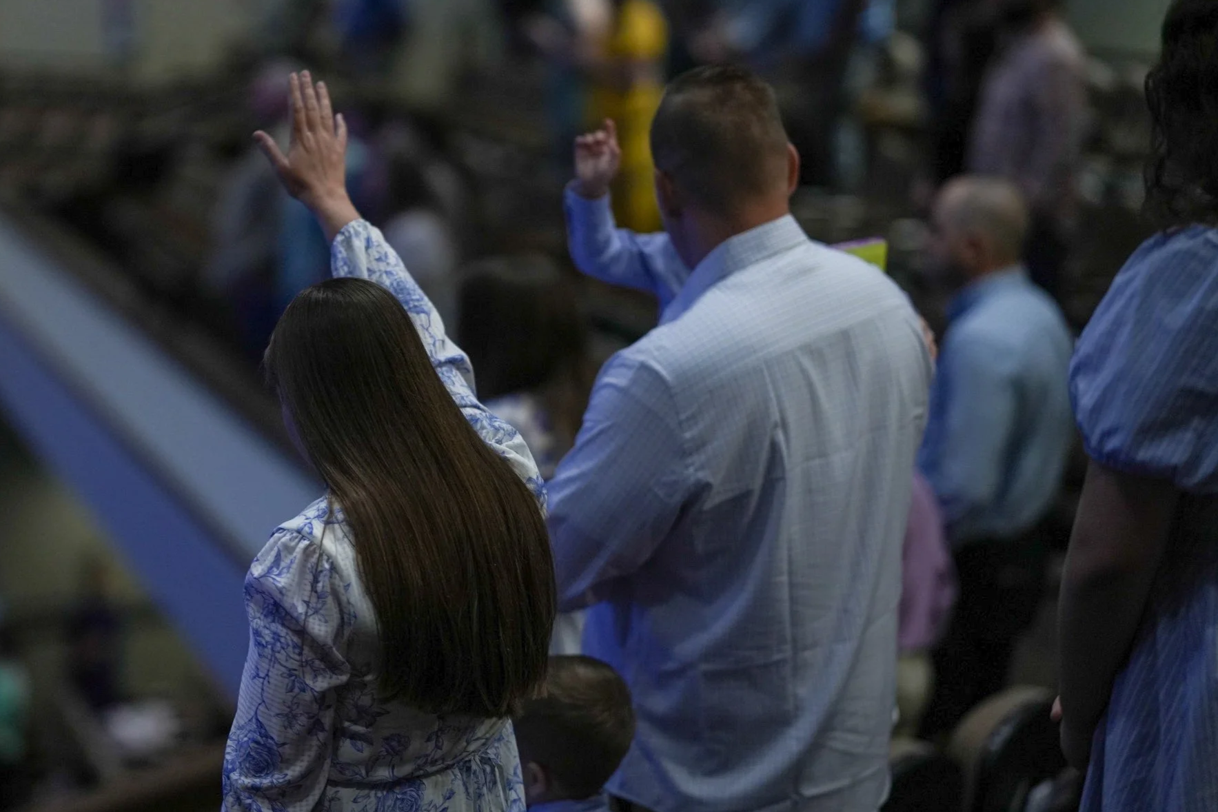 A photo of a family in a church service.
