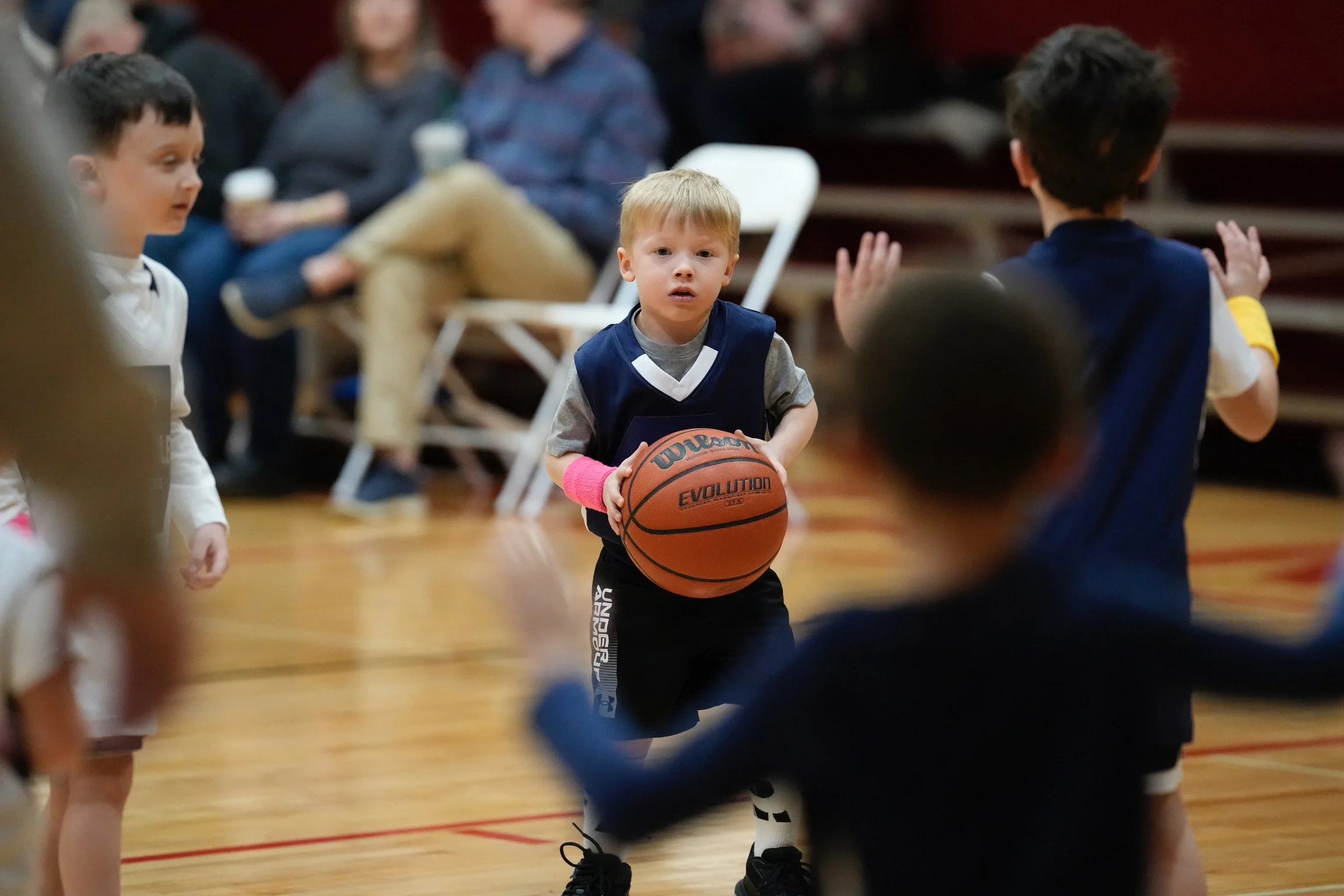 A photo of a kid playing basketball in the Manley Gym
