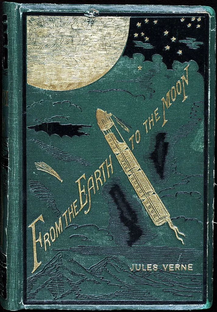 Vintage green book cover titled 'From the Earth to the Moon' by Jules Verne, featuring an illustration of a rocket launching towards the moon with stars and clouds in the background.