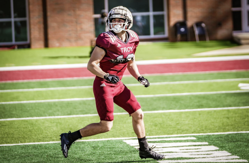 College football player running on the field during practice