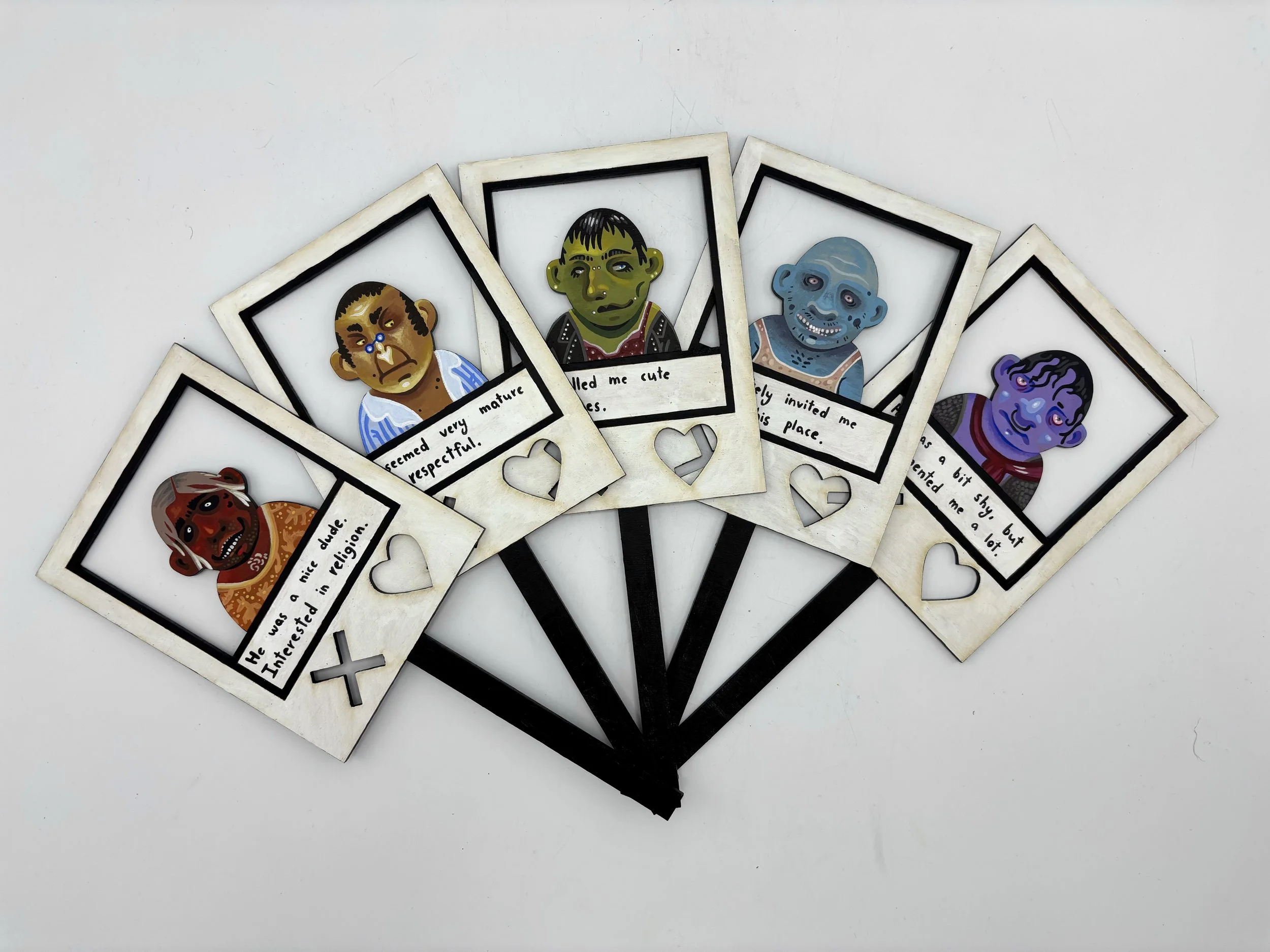 “Tinder Terror”, each portrait is 5 x 6 x 4 inches, acrylic on laser-cut wooden templates. 