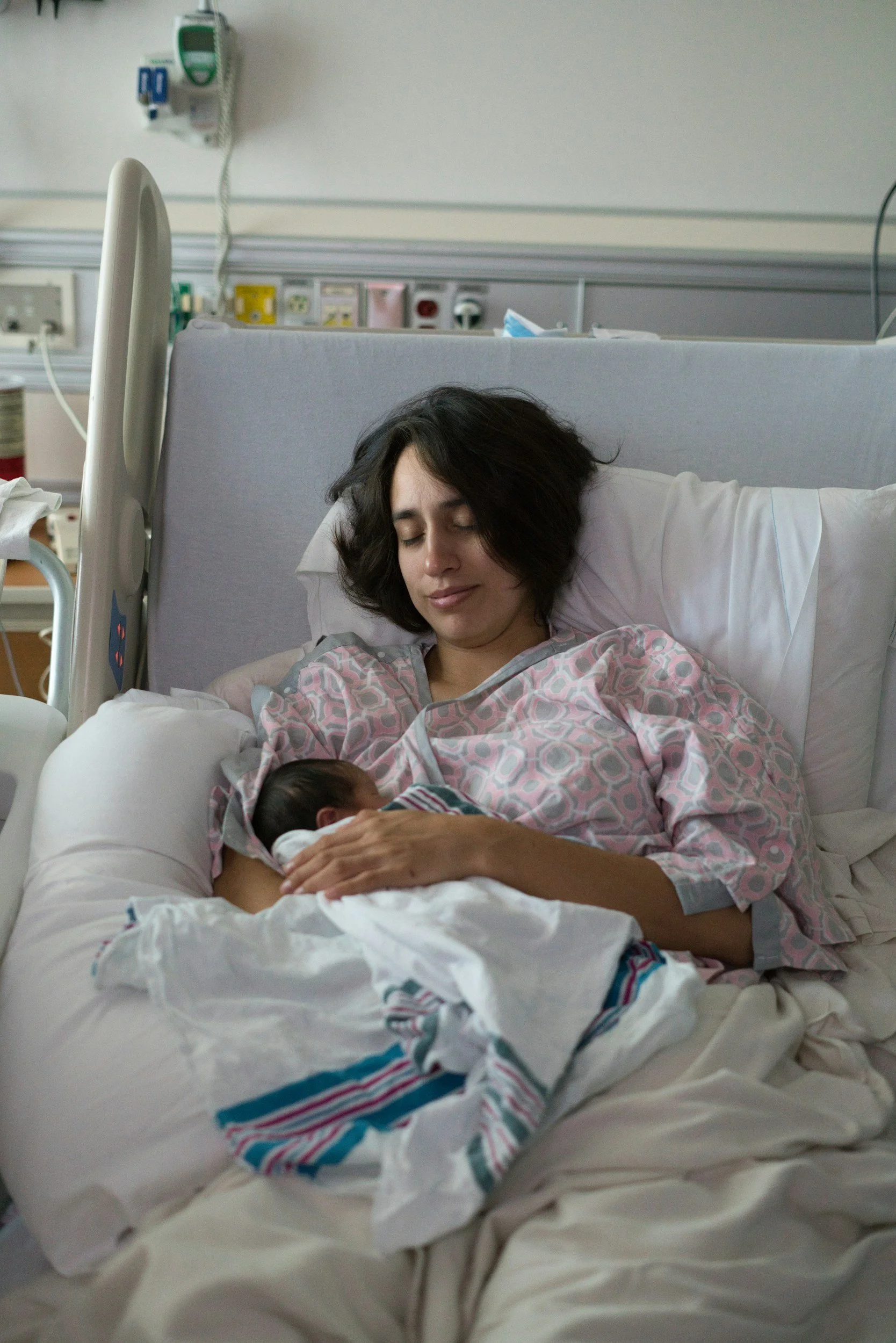 Postpartum mom holding her newborn baby representing newborn sleep support from a Houston pediatric sleep consultant