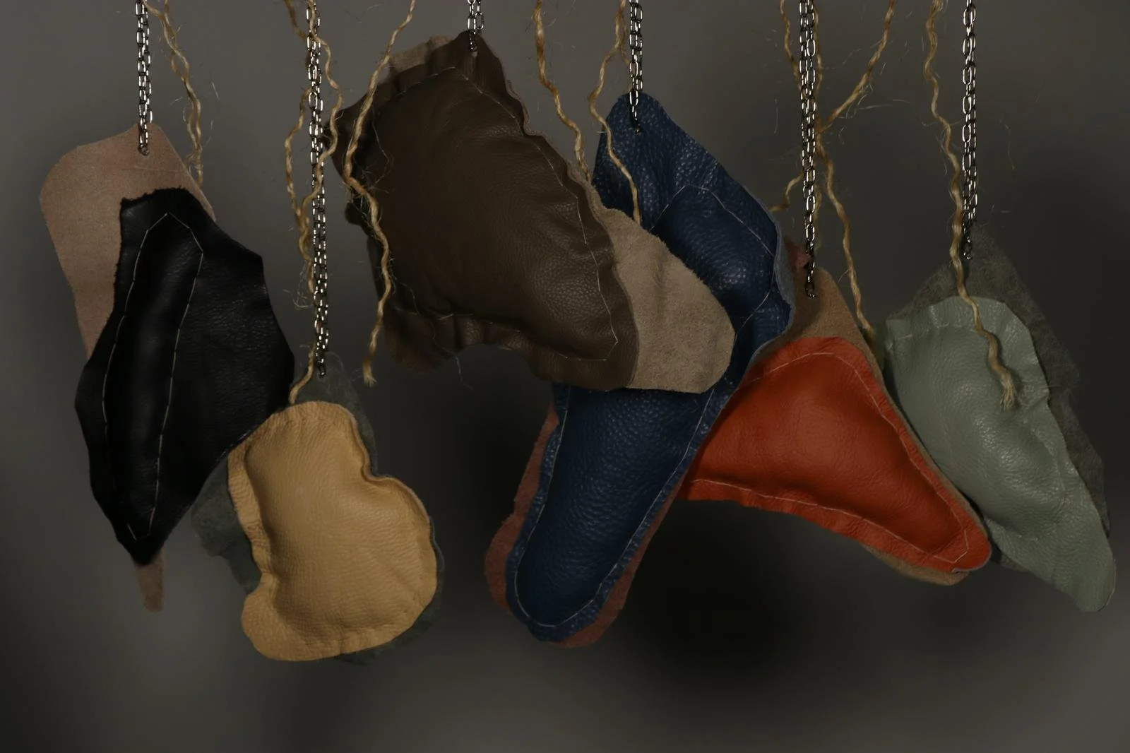 Glitch II, 2026, 
Recycled leather, wool, metal chain, wooden panel, and rope
H:165 x W:60 x D:5 cm