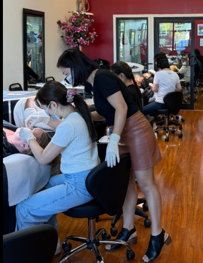 Inside HuongDao Brow & Lash beauty salon in Avon, Indiana, with clients receiving beauty services.