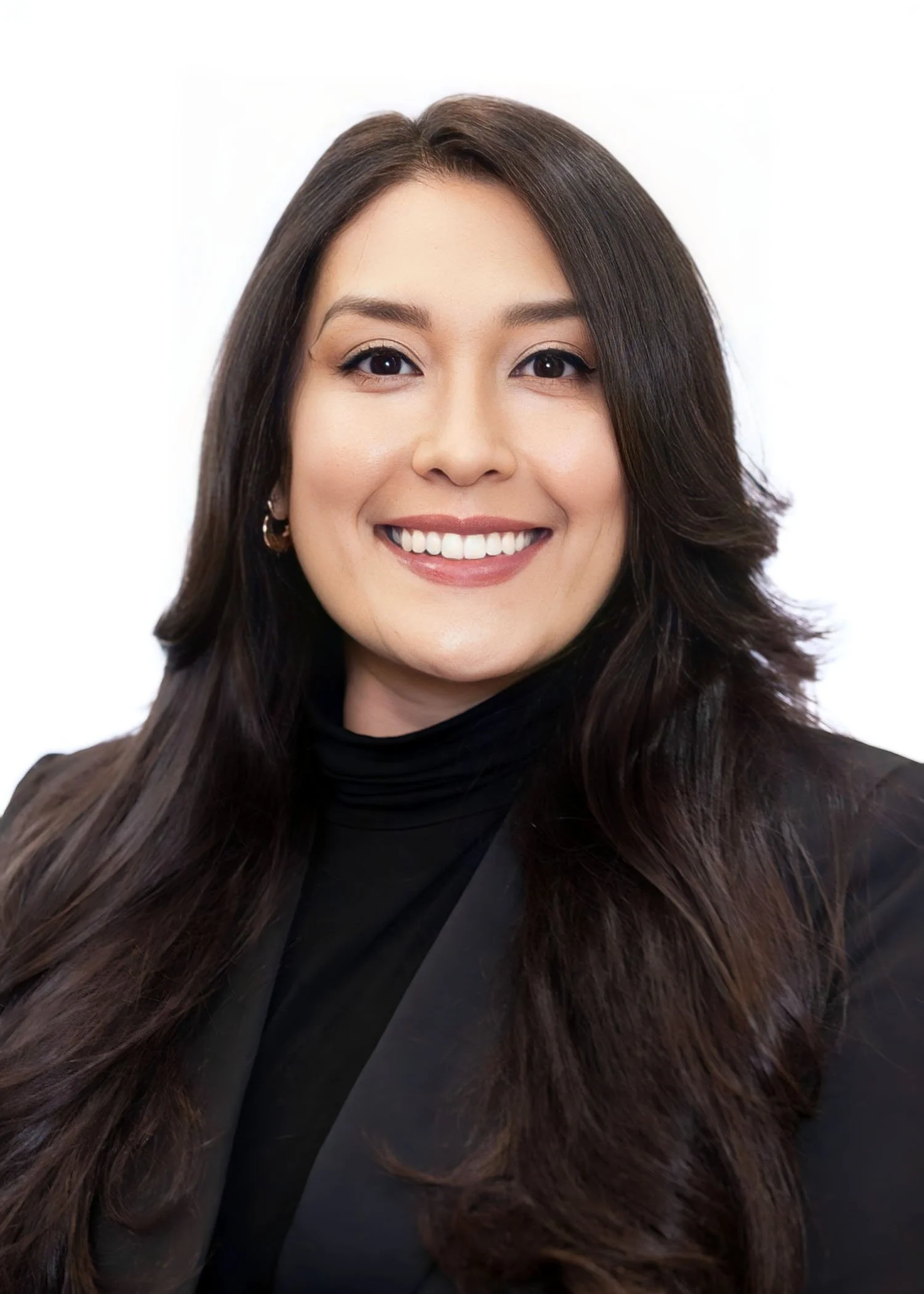 A smiling woman with long dark hair, wearing a black turtleneck and black blazer, against a white background.