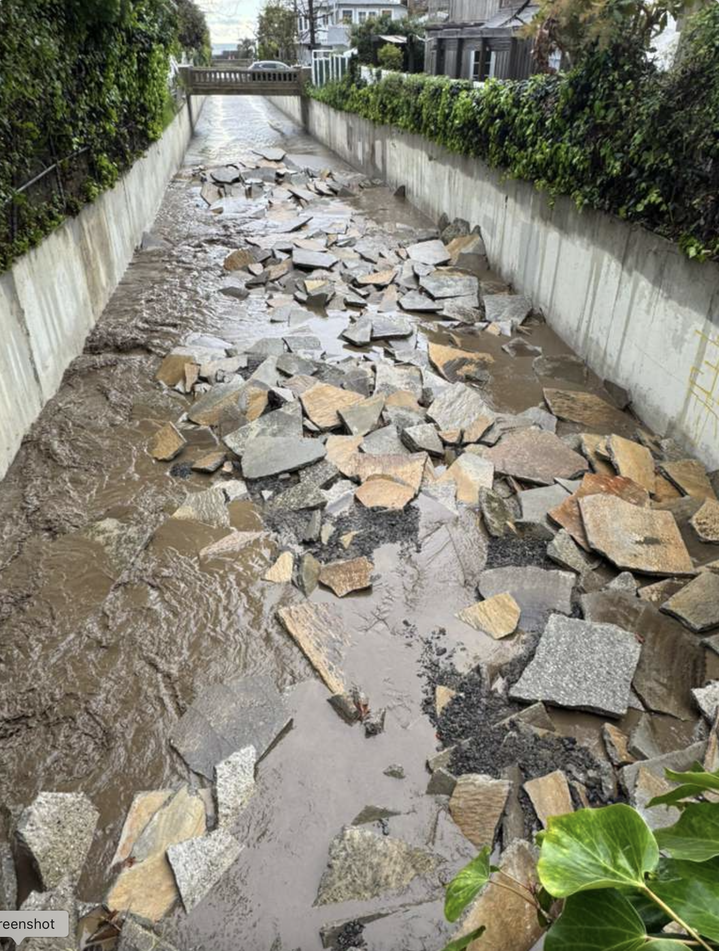 Concrete Slabs Clog Flood Channel/Storm Water Reaches Yards