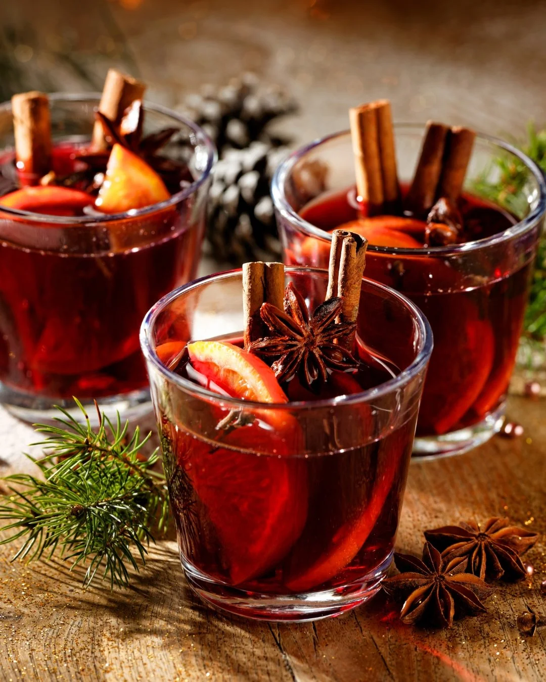 A colorful charcuterie board with fresh vegetables, cheeses, meats, nuts, grapes, and dips, including a chalkboard sign that reads "Rosemary Spiced Nuts."