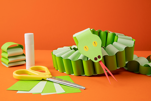 Green-paper-snake-and-art-supplies.png