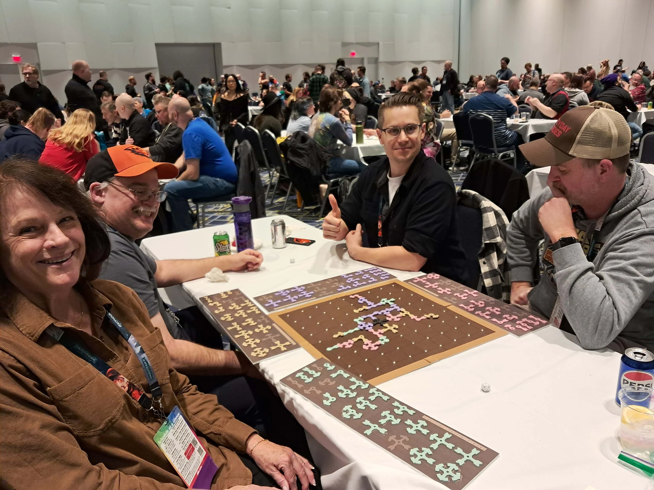 People gathered at tables in a conference room, engaging in a puzzle activity.