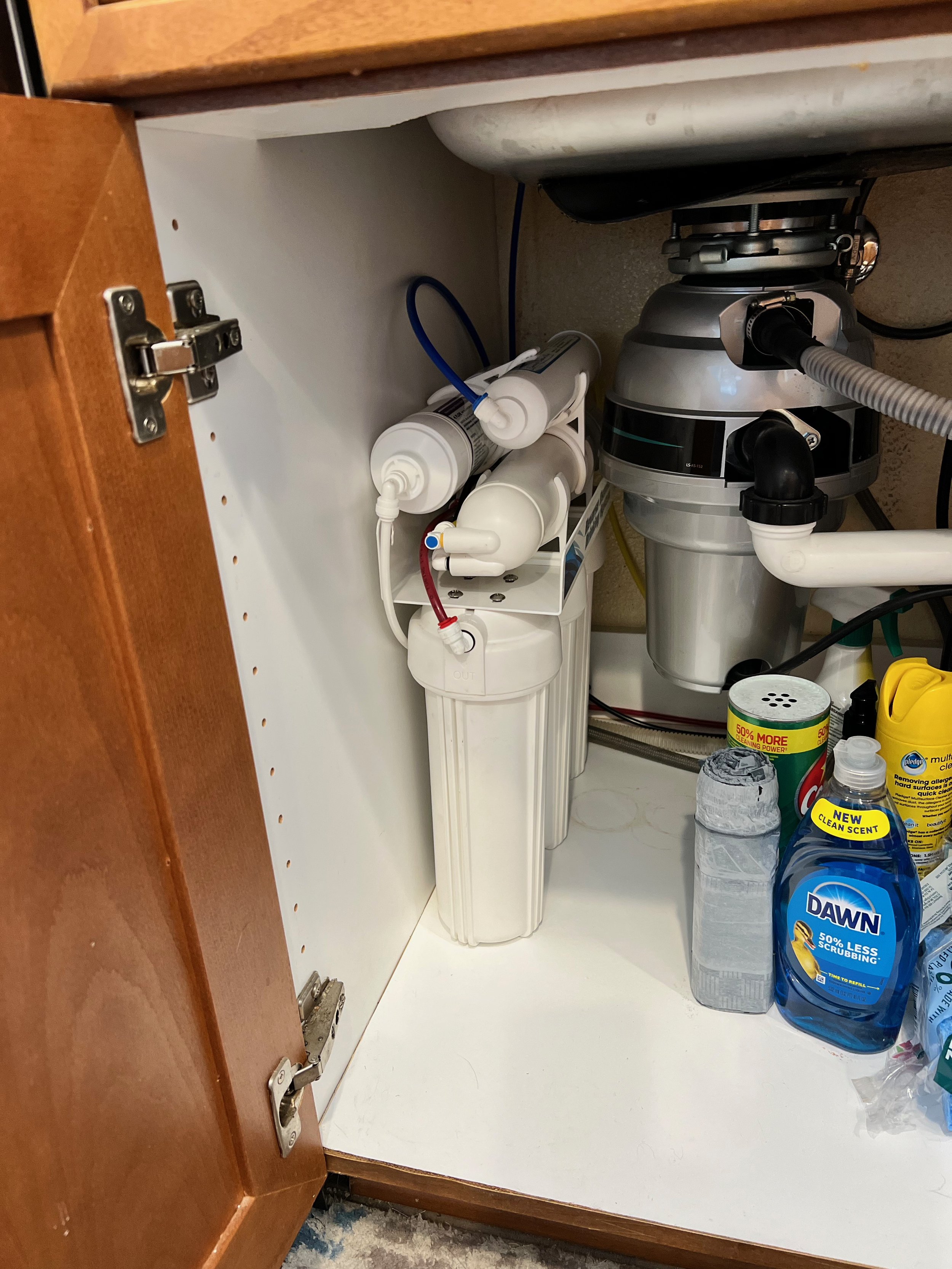 Compact reverse osmosis water filter system installed under a kitchen sink in a San Diego home.