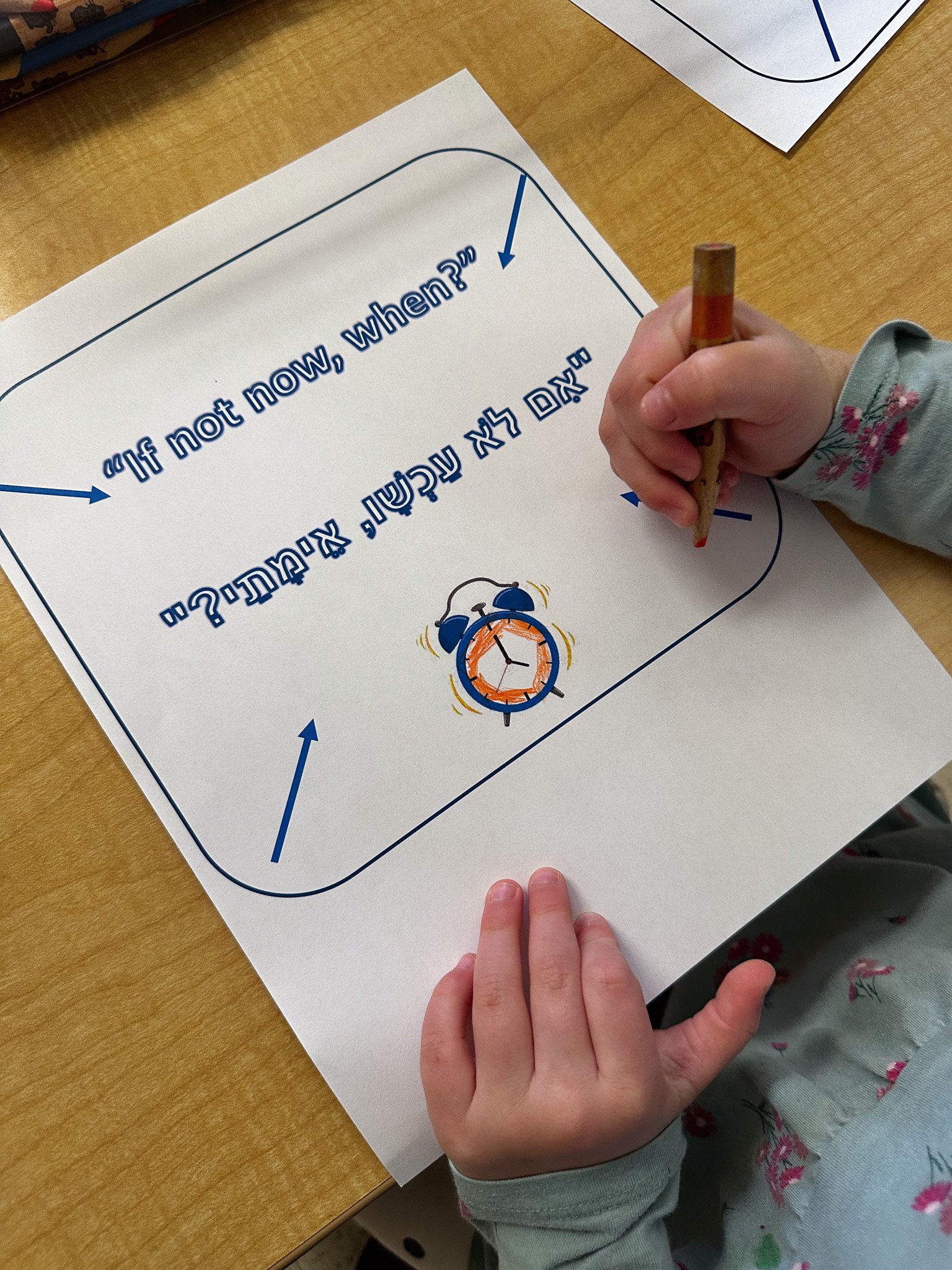 School assignment sheet with a quote, a drawing of a clock, and blue arrows.