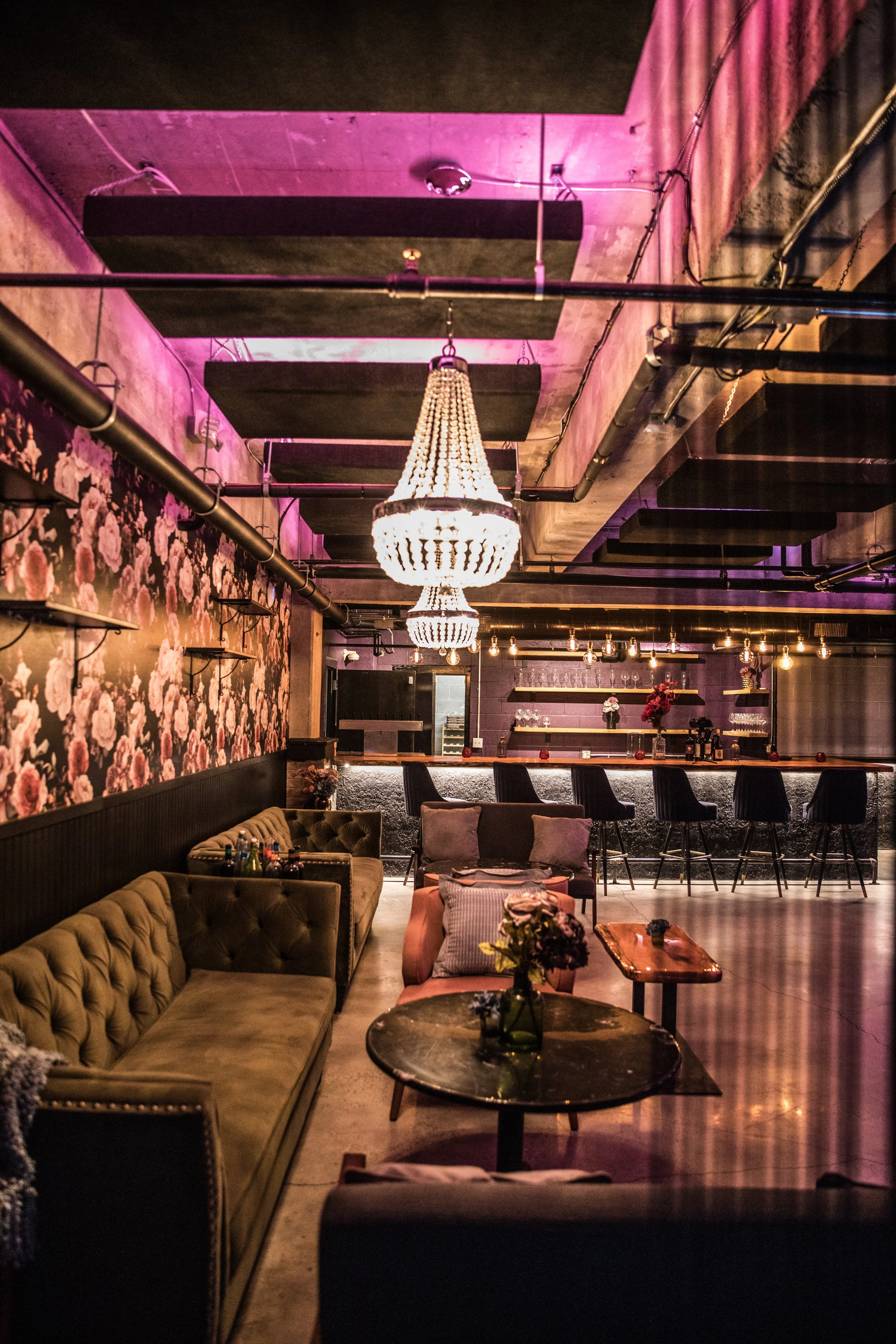 Guests at a corporate event talking and eating on couches around a table