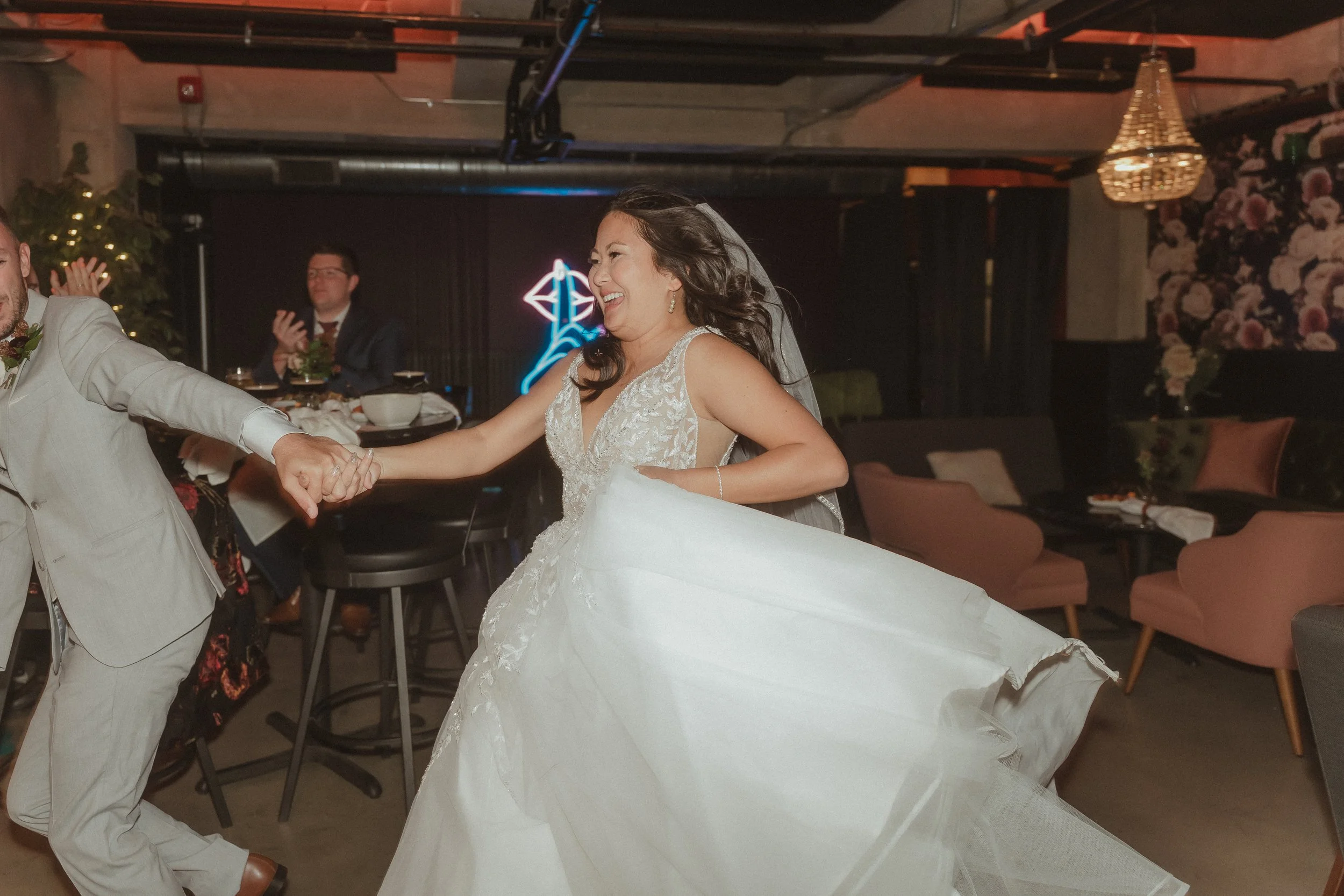 Wedding guests dancing in front band singing on of stage
