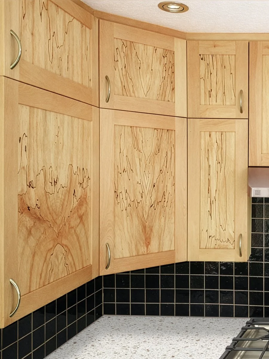Closeup detail of book-matched spalted maple custom cabinetry kitchen project constructed by ETaylor&Co