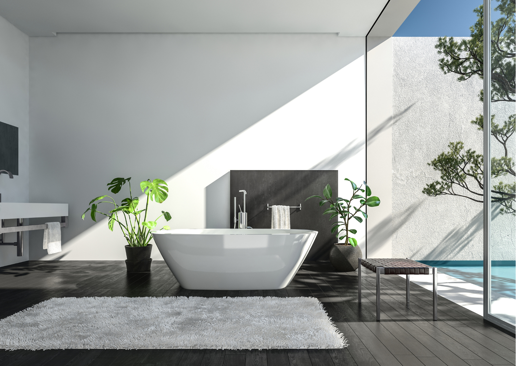 Modern bathroom with a white bathtub, black wooden floors, and large floor-to-ceiling window revealing outdoor trees. Decor includes potted plants, a white shag rug, a bench, and minimal fixtures.