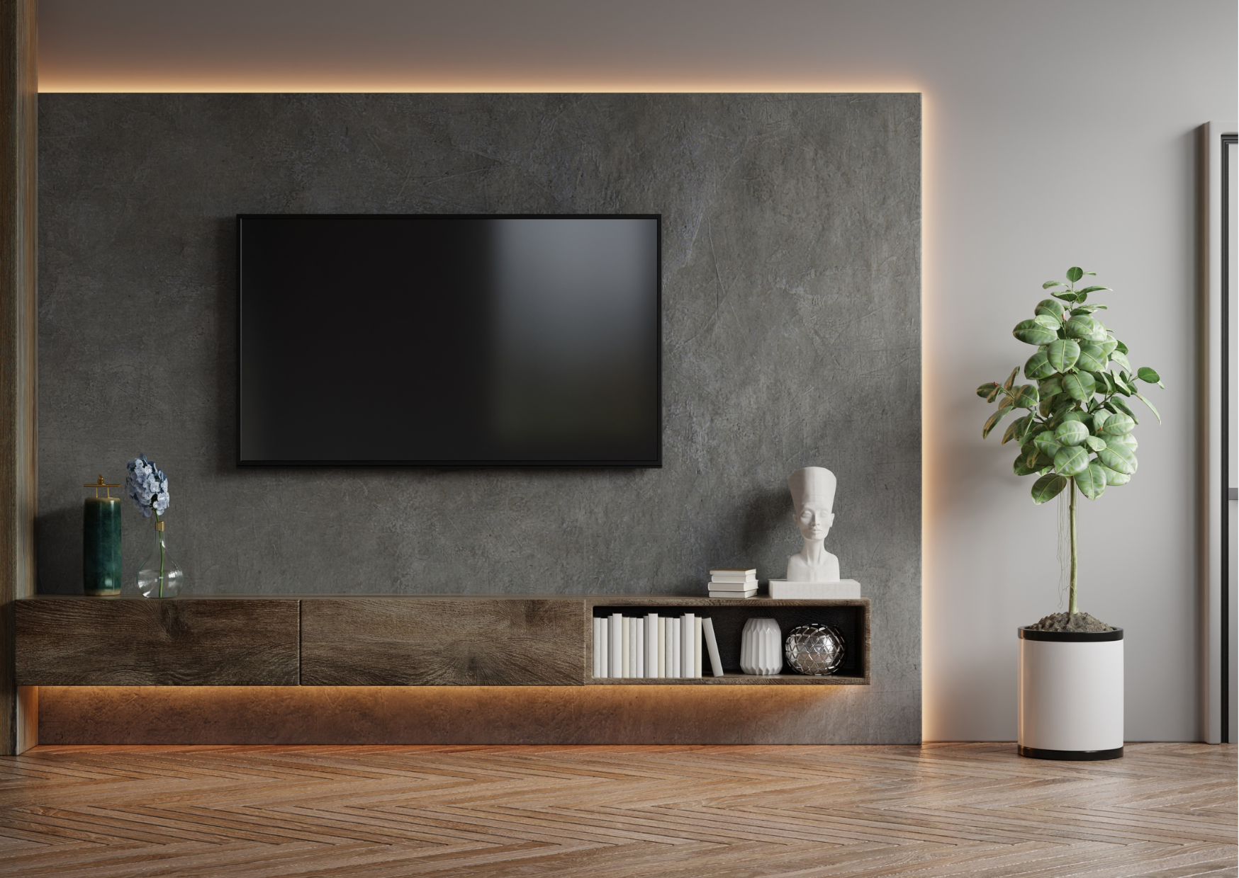 Modern living room with a wall-mounted flat-screen TV, a wooden shelf with decorative objects, and a potted plant next to a large window.