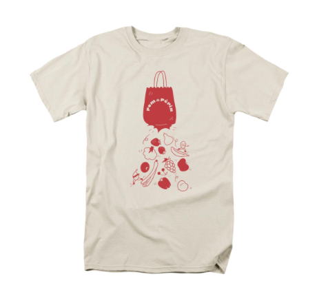 Beige T-shirt with red graphic of a grocery bag and various foods like vegetables and fruit falling out.