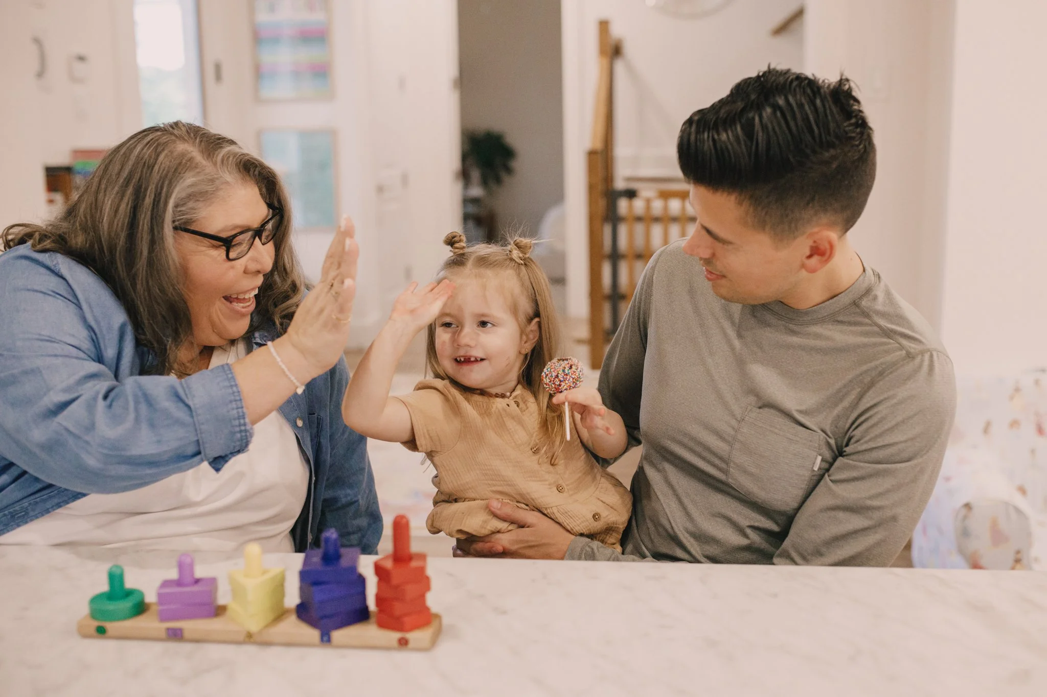 child and adult high fiving