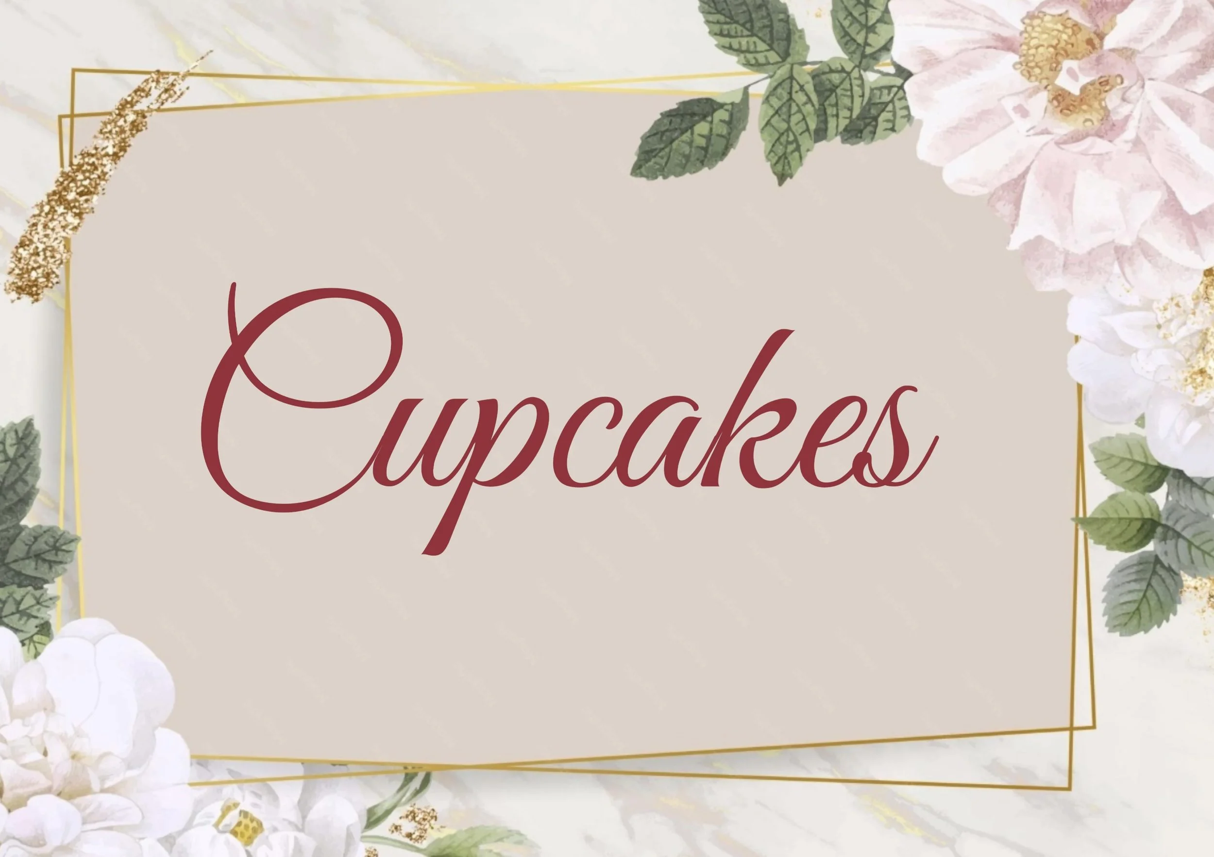 A decorative sign with the word 'Cupcakes' written in script, surrounded by floral and leafy accents with gold geometric details.