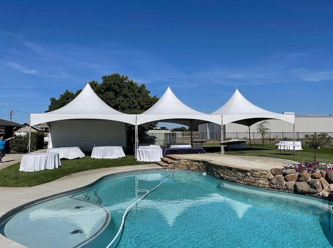 Party tents with sidewalls and tables set up for a party in Stockton, California.