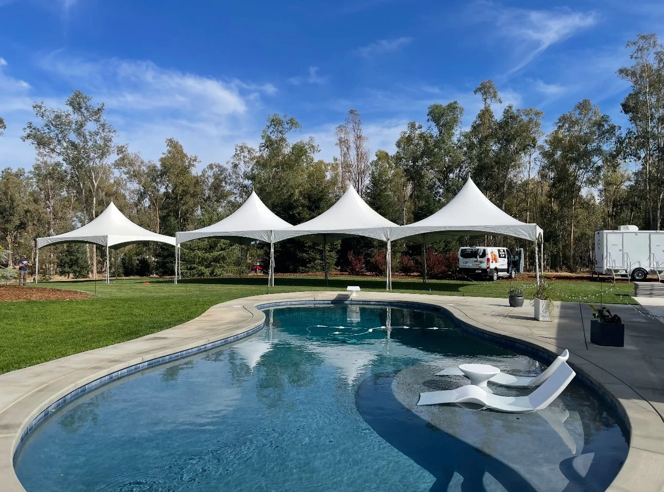 Tents set up by the water for a poolside party in Lodi, CA.