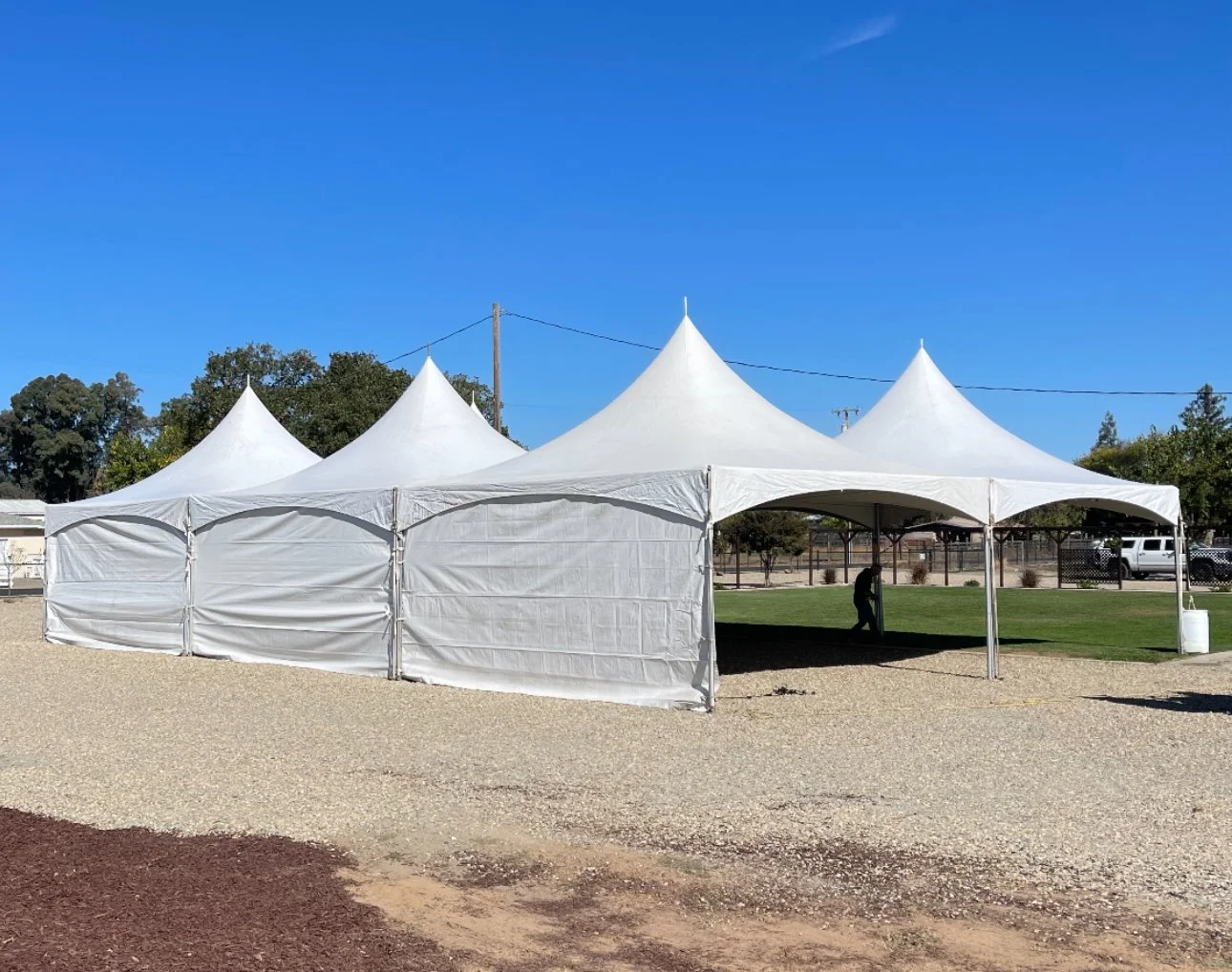 Tents set up with sidewalls for an event in Lodi, CA.