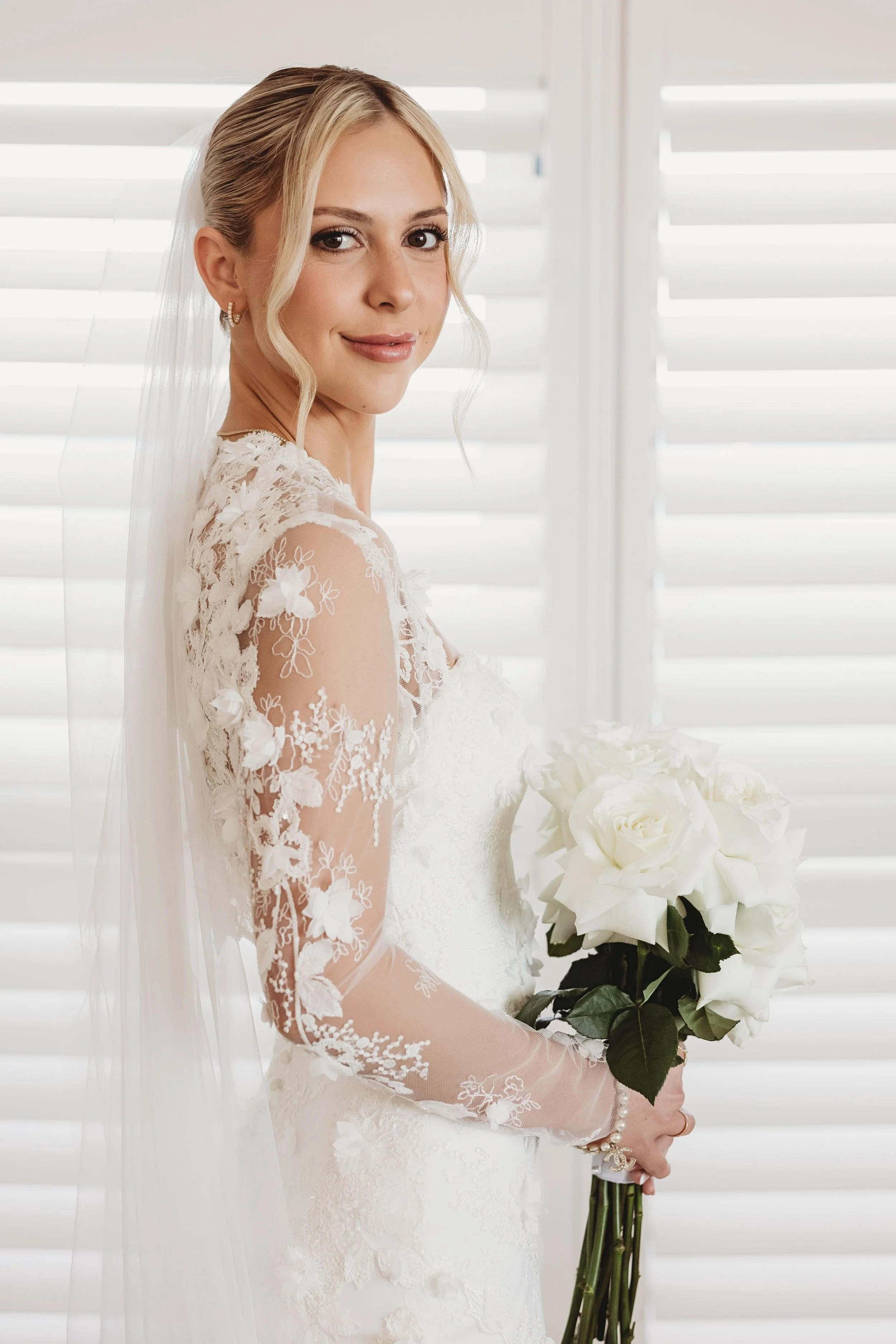 Bride in lace wedding dress holding white roses in Palm Beach, FL | Shelby Eve Photography