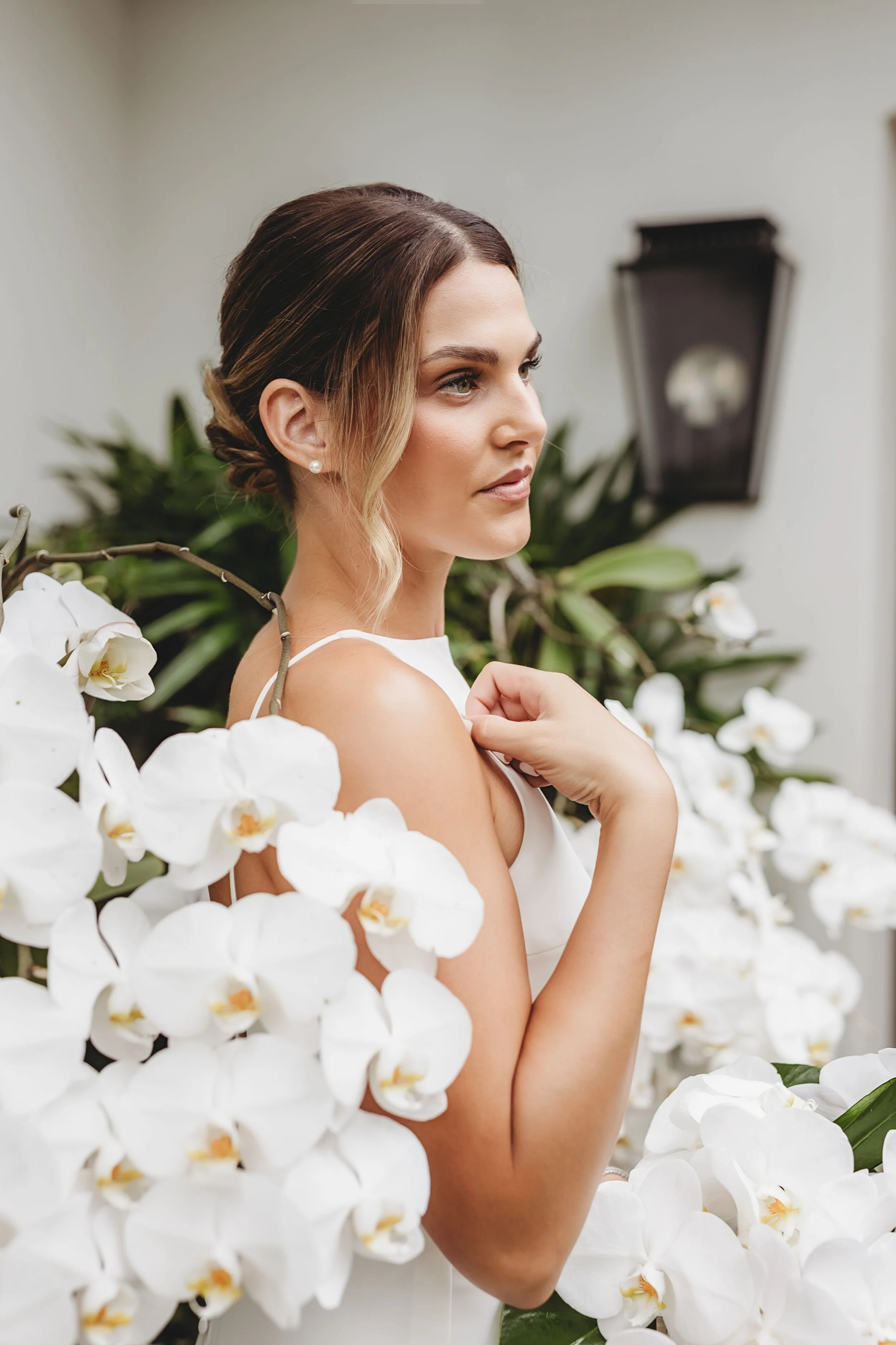 Woman in white dress surrounded by white flowers in Palm Beach, FL | Shelby Eve Photography